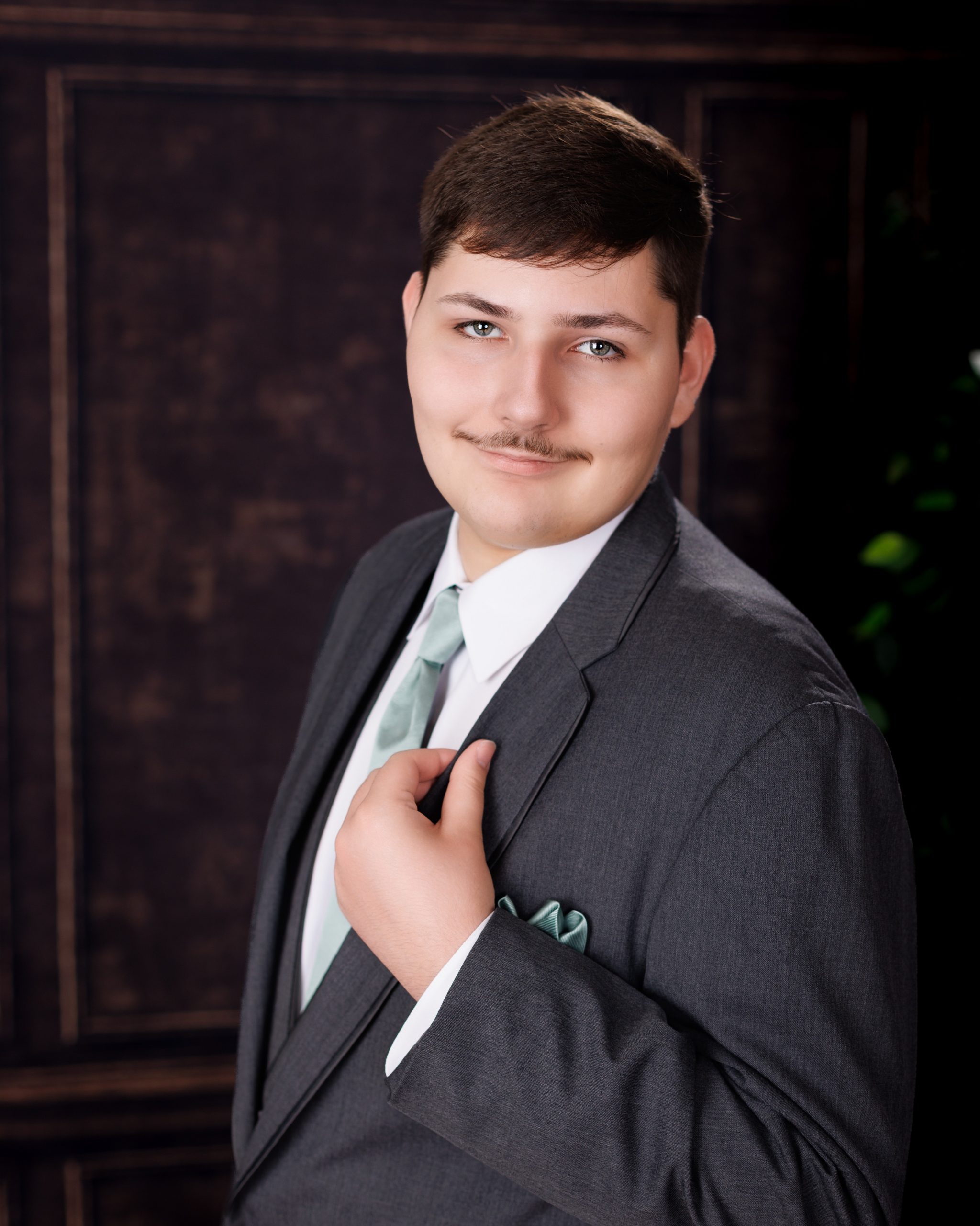 Tobias drumming professionally in formal attire during Dearborn senior photography session