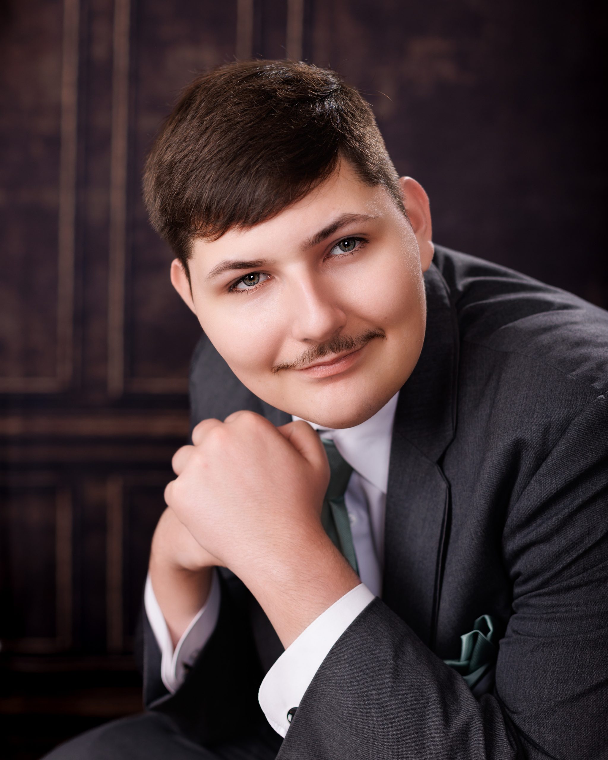 Tobias drumming professionally in formal attire during Dearborn senior photography session
