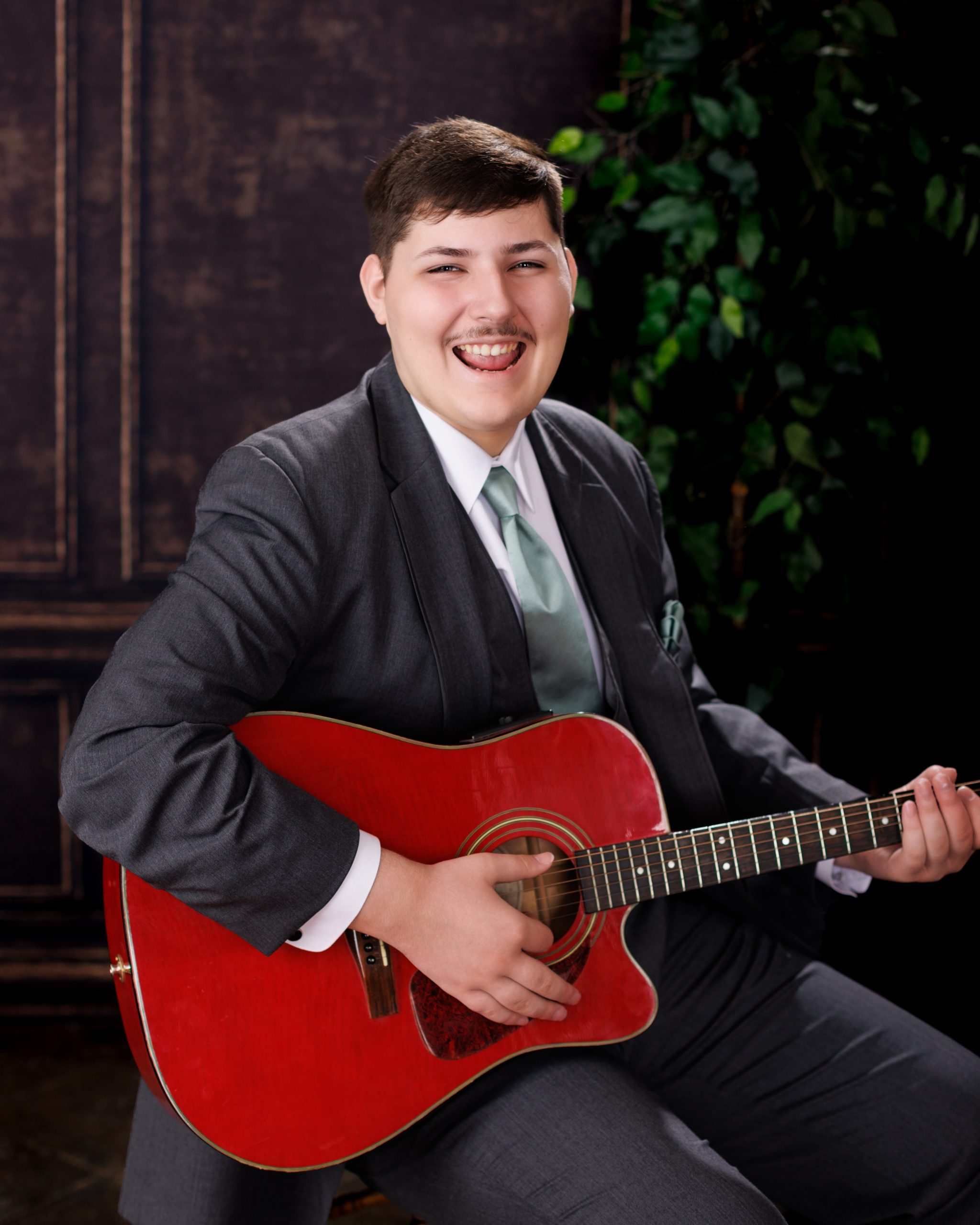 Tobias drumming professionally in formal attire during Dearborn senior photography session
