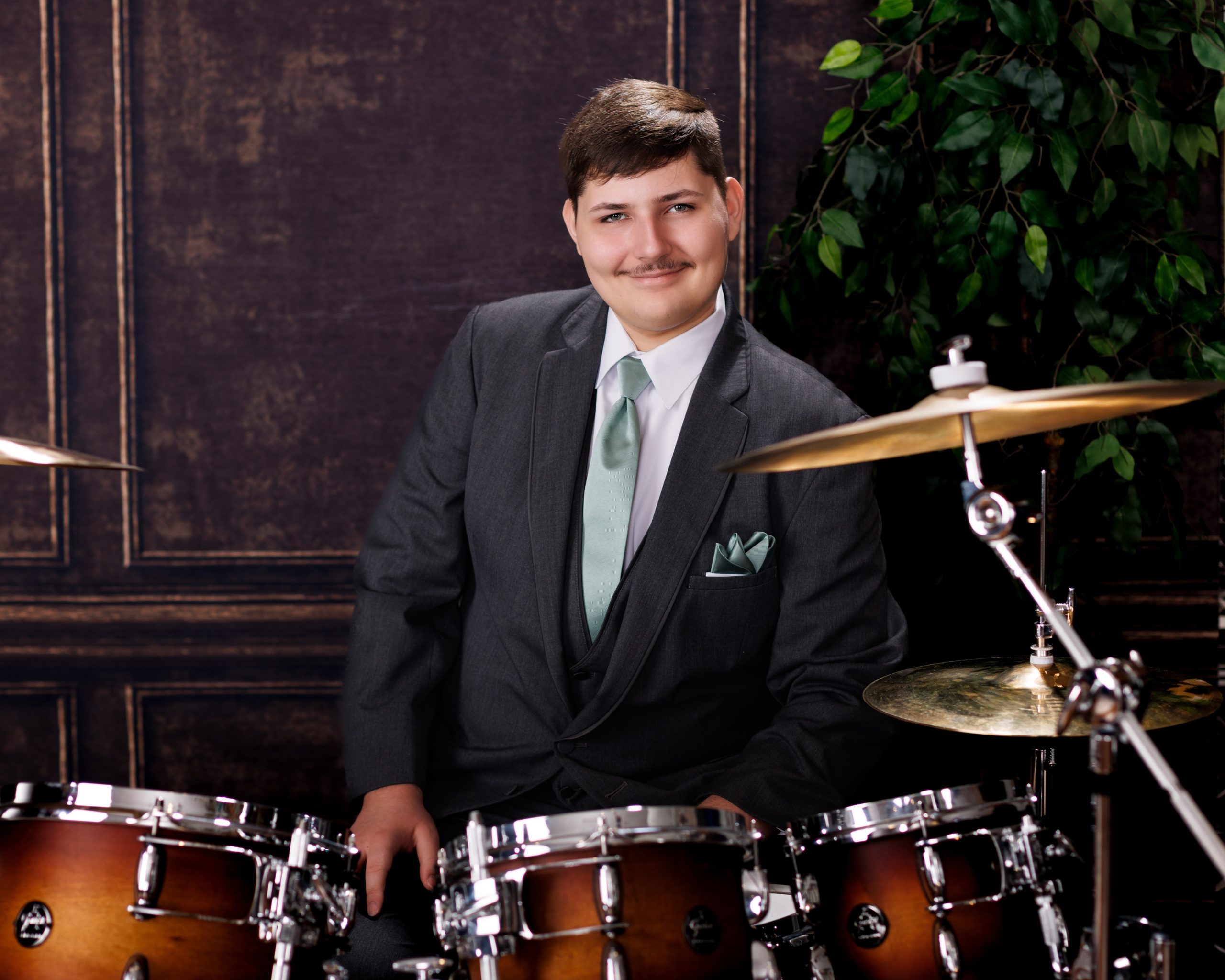 Tobias drumming professionally in formal attire during Dearborn senior photography session