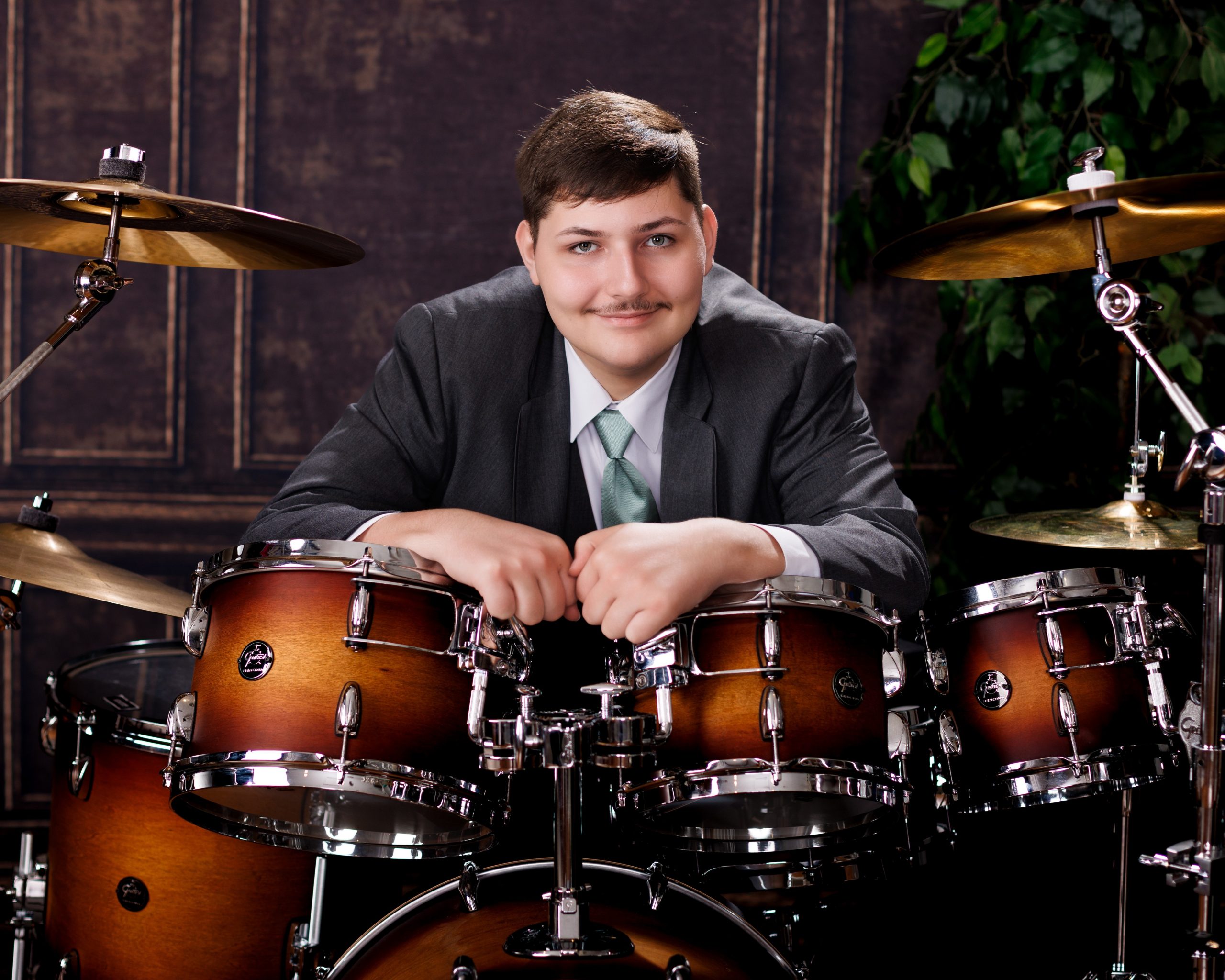 Tobias drumming professionally in formal attire during Dearborn senior photography session