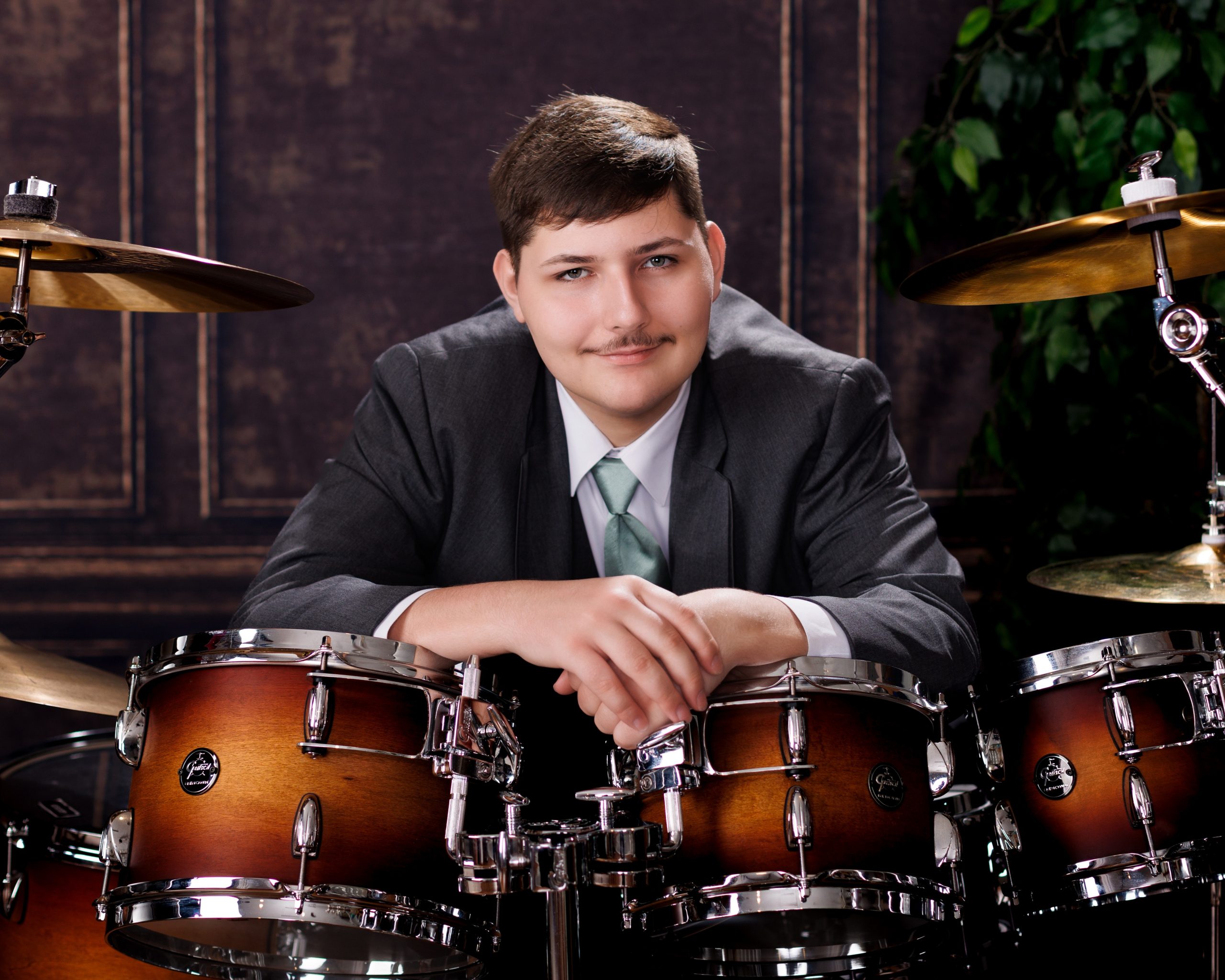 Tobias drumming professionally in formal attire during Dearborn senior photography session