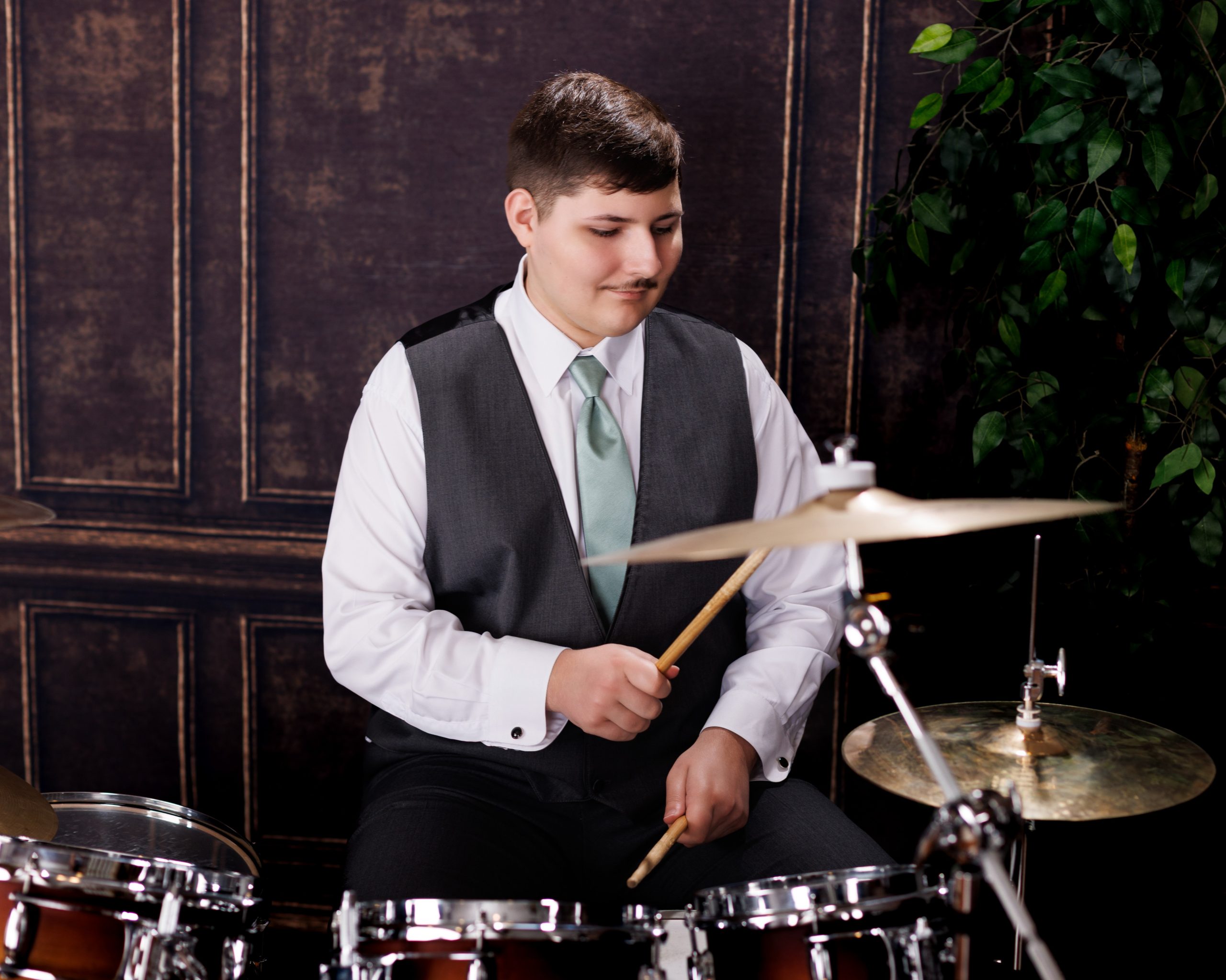 Tobias drumming professionally in formal attire during Dearborn senior photography session