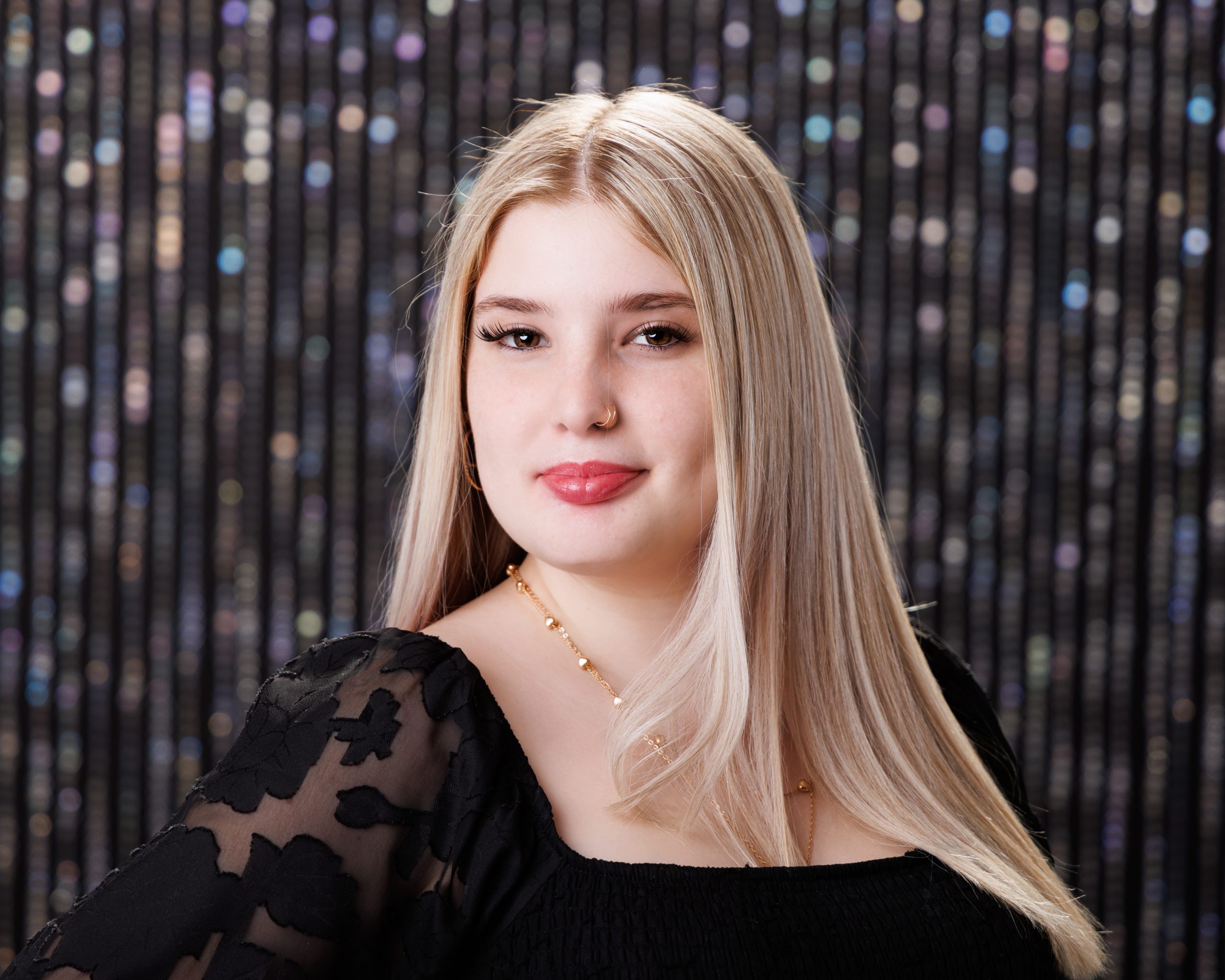 Graduation portrait of Dearborn senior Alysha in blue gown holding diploma