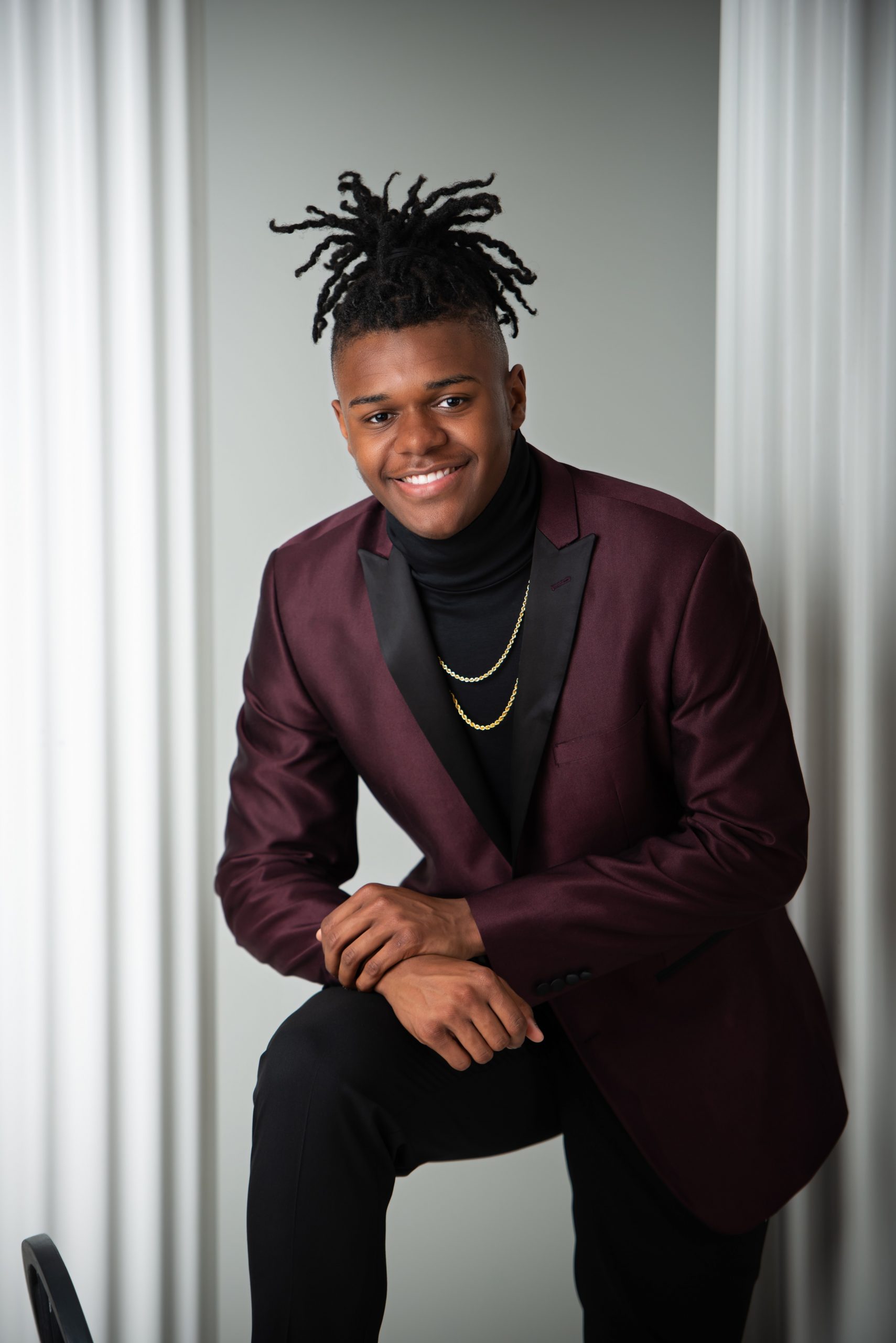 Frederick holding Jordan basketball in formal attire for Downriver Detroit photo session