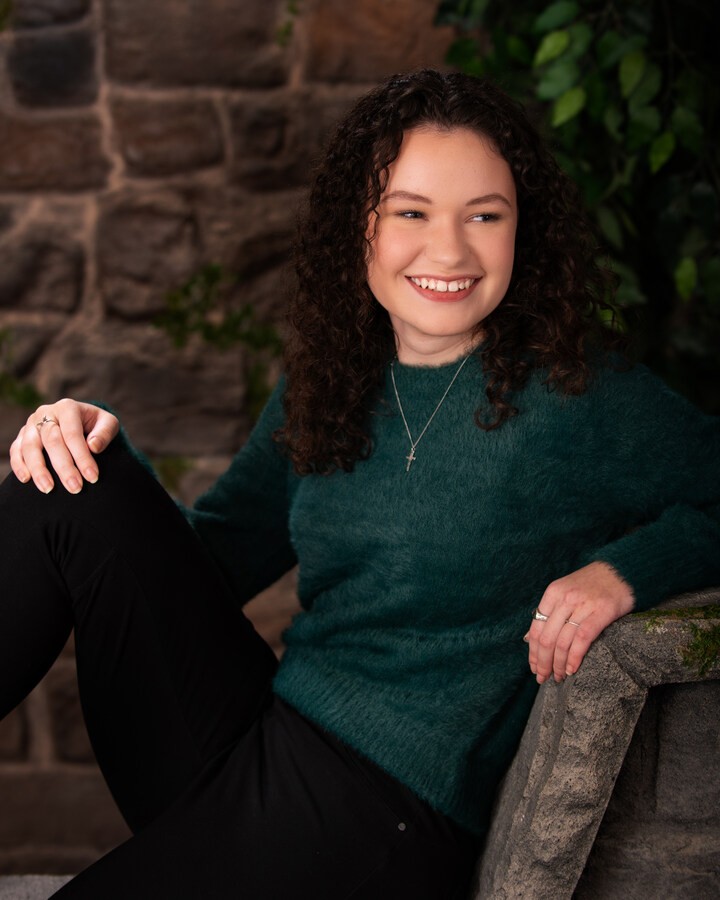 Downriver senior photography - student sitting with '2024' letters against white backdrop