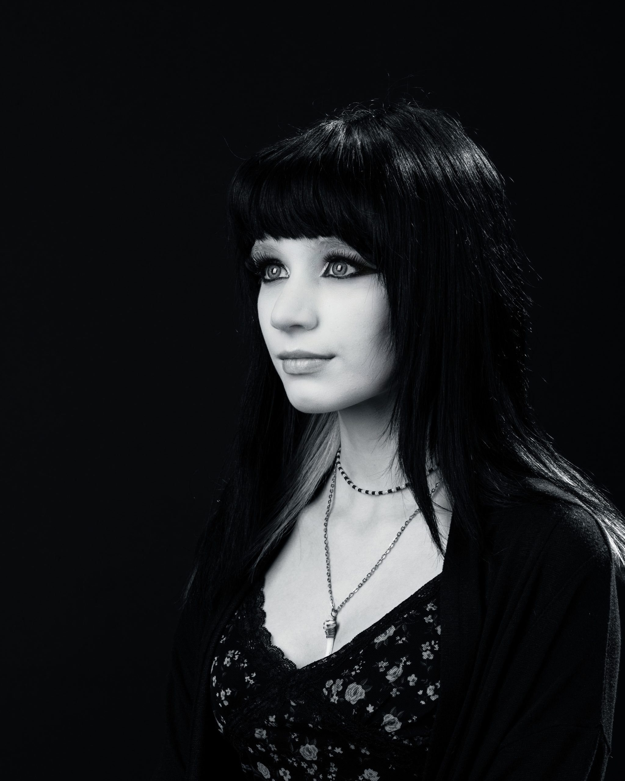 Close-up of Ashley's gothic makeup and black hair with purple highlights for Downriver senior photography