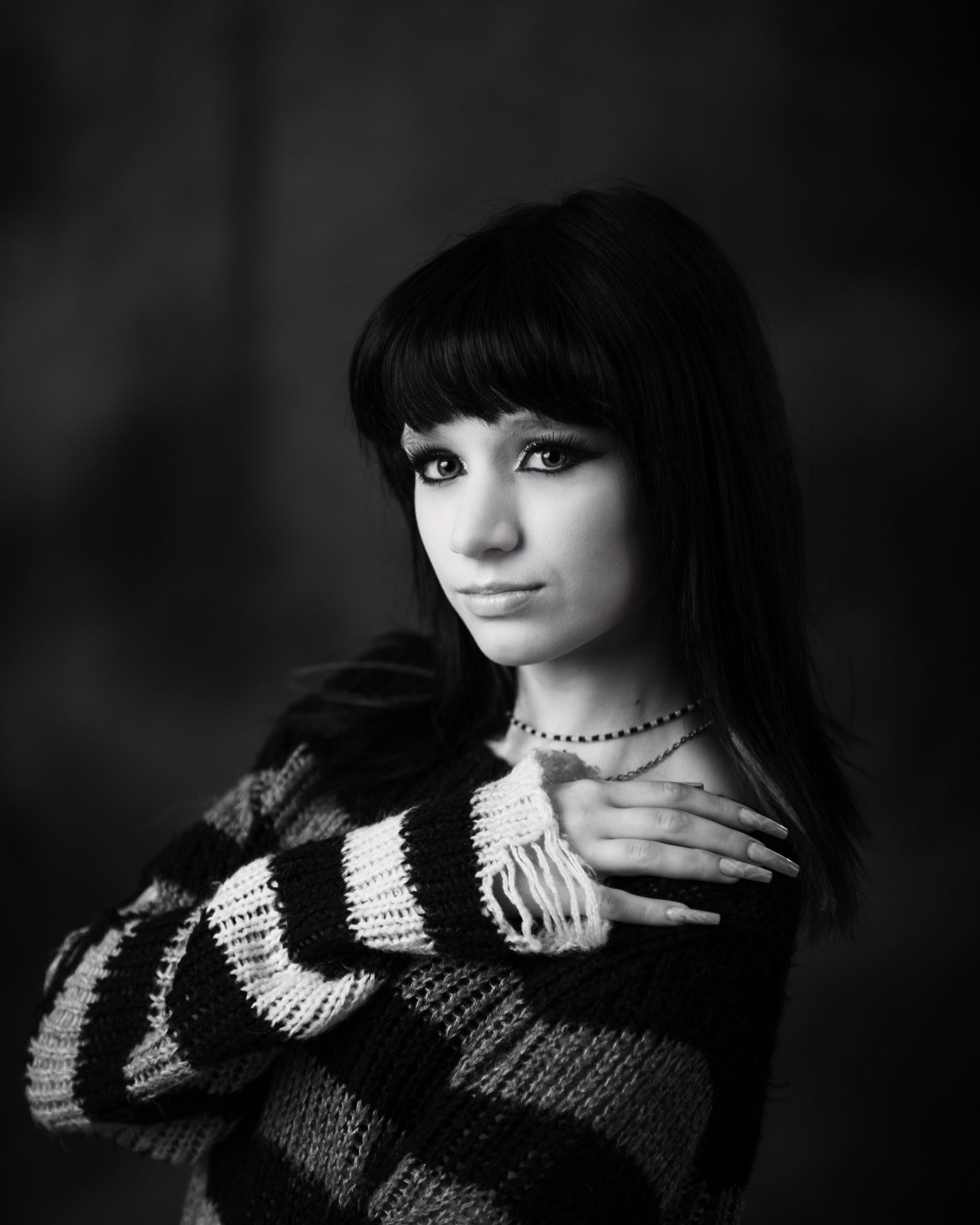 Close-up of Ashley's gothic makeup and black hair with purple highlights for Downriver senior photography