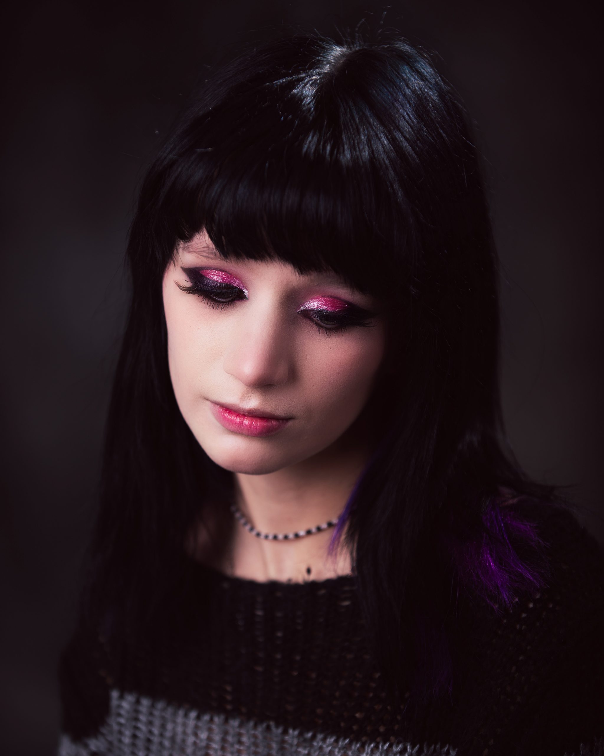 Close-up of Ashley's gothic makeup and black hair with purple highlights for Downriver senior photography