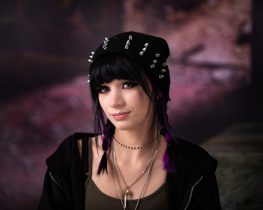 Ashley wearing black knit top against dark background for Downriver senior portraits