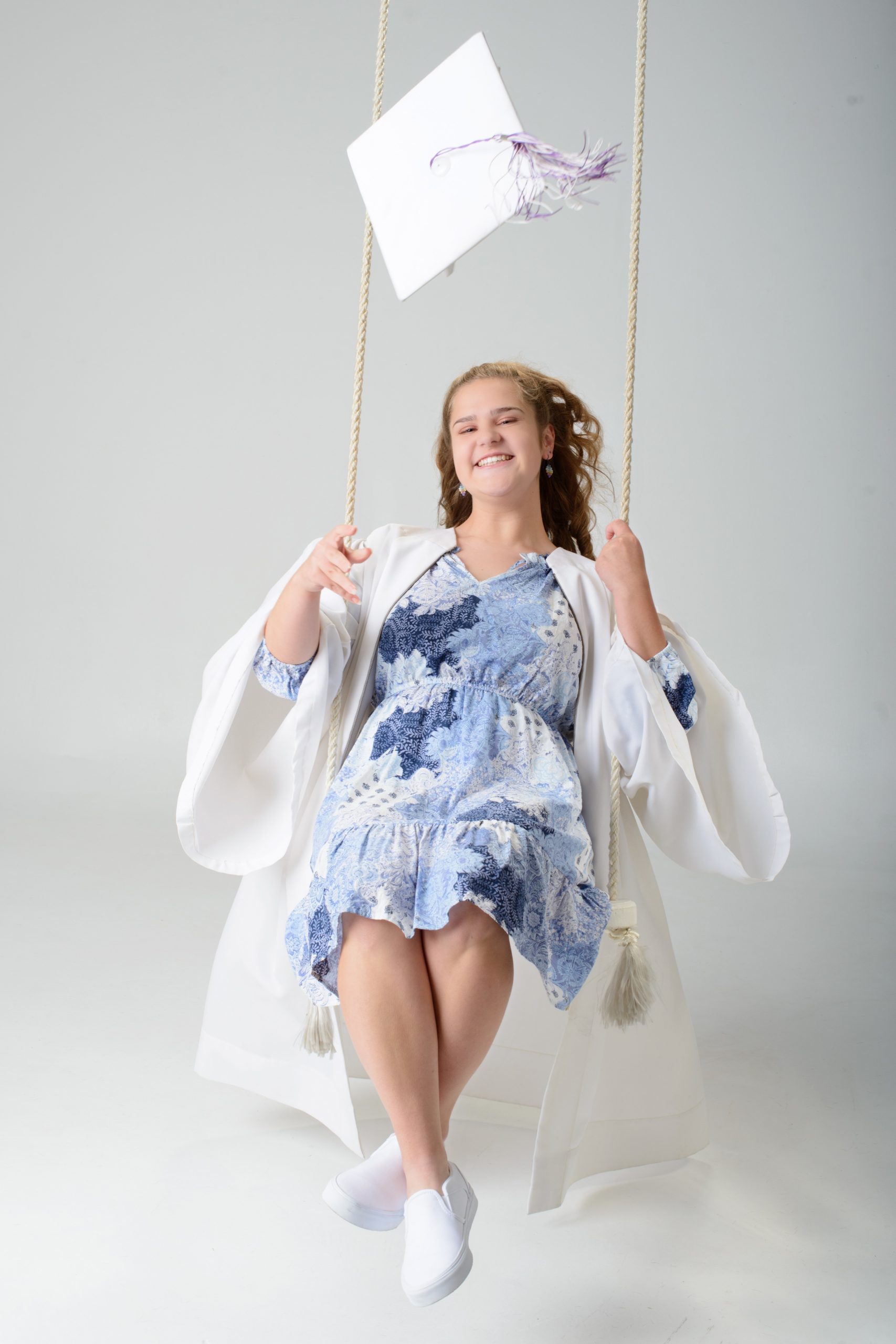 Lauren seated on white blocks with 2025 letter props for Downriver senior photography