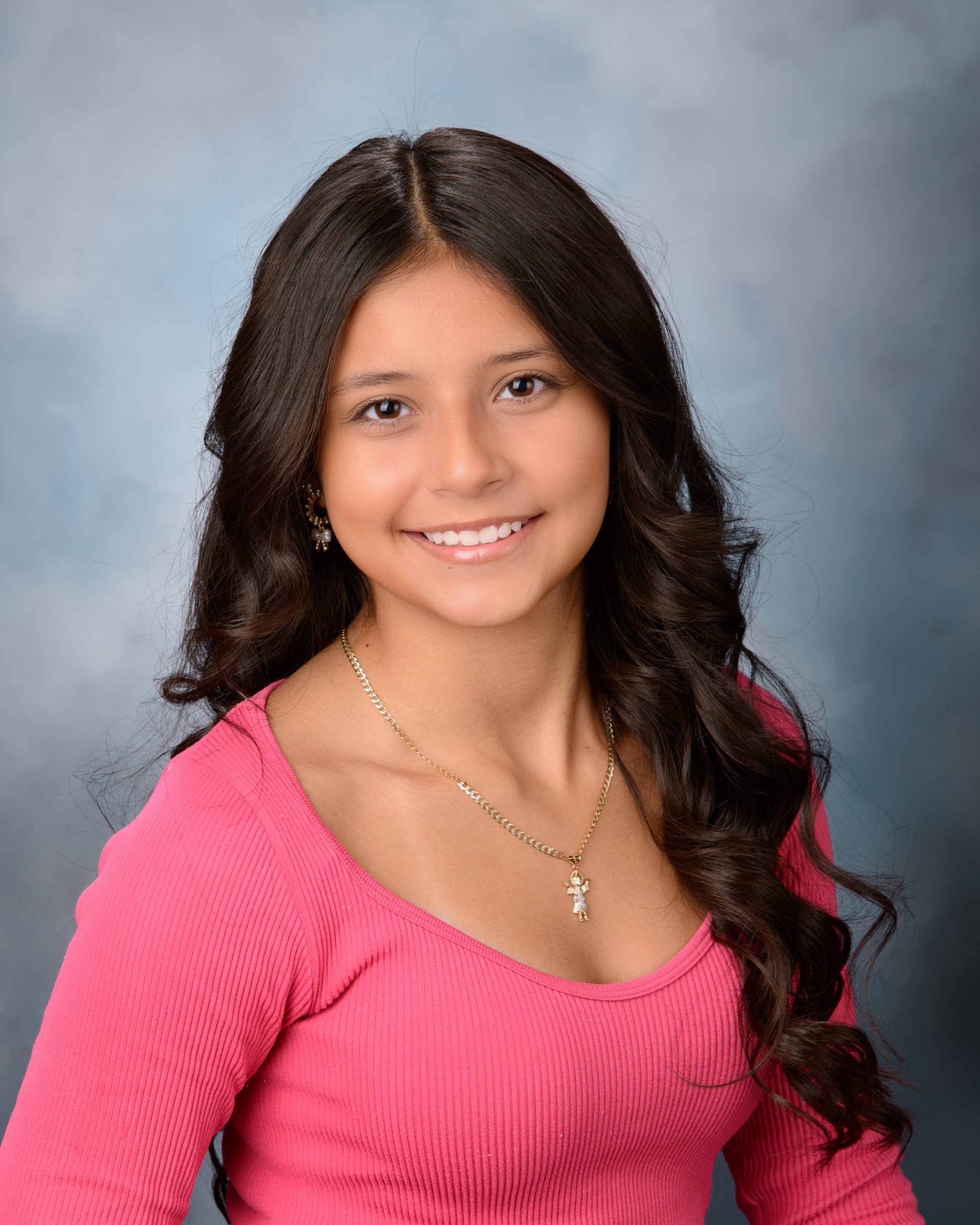 Senior headshot featuring braided hairstyle, black off-shoulder top, pearl necklace, and Downriver photography studio background