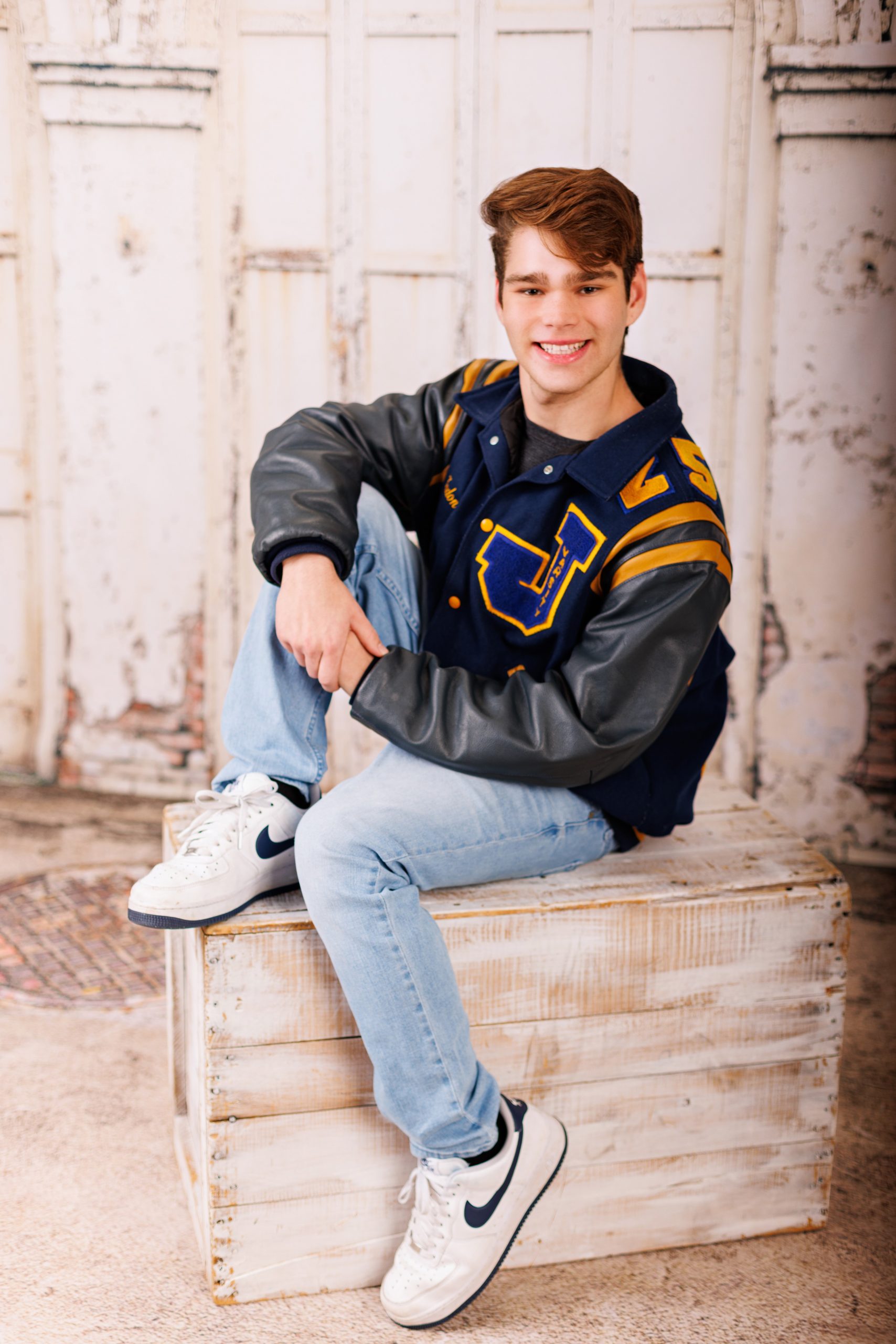 Formal senior photo of Jefferson High School student in navy suit and tie