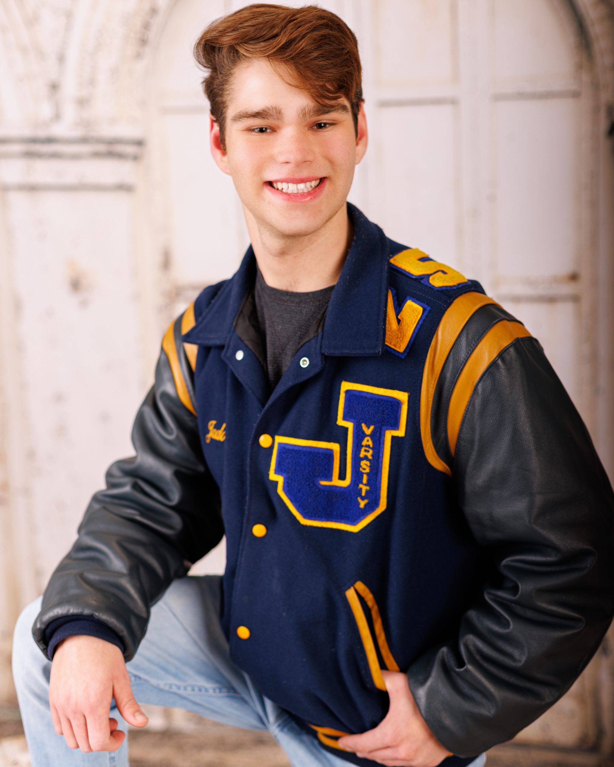 Formal senior photo of Jefferson High School student in navy suit and tie