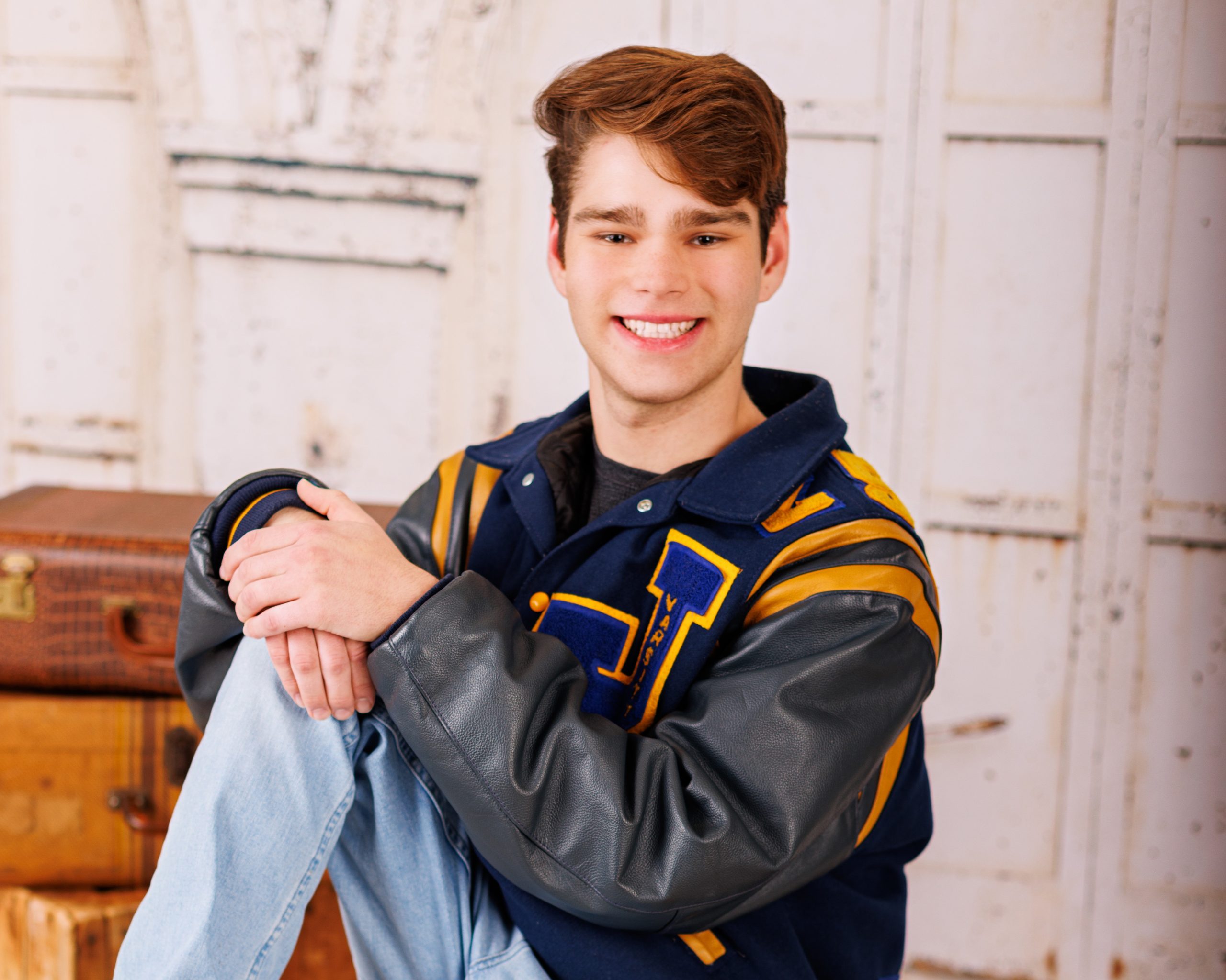 Formal senior photo of Jefferson High School student in navy suit and tie