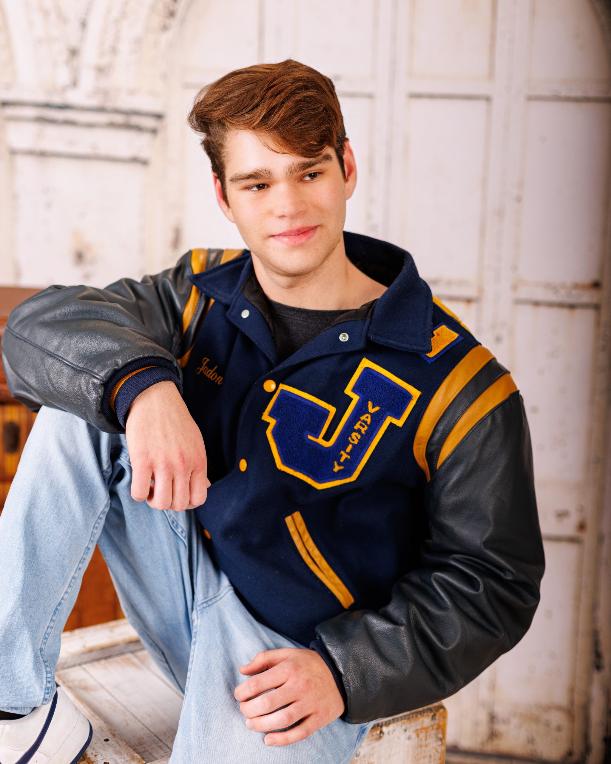 Formal senior photo of Jefferson High School student in navy suit and tie