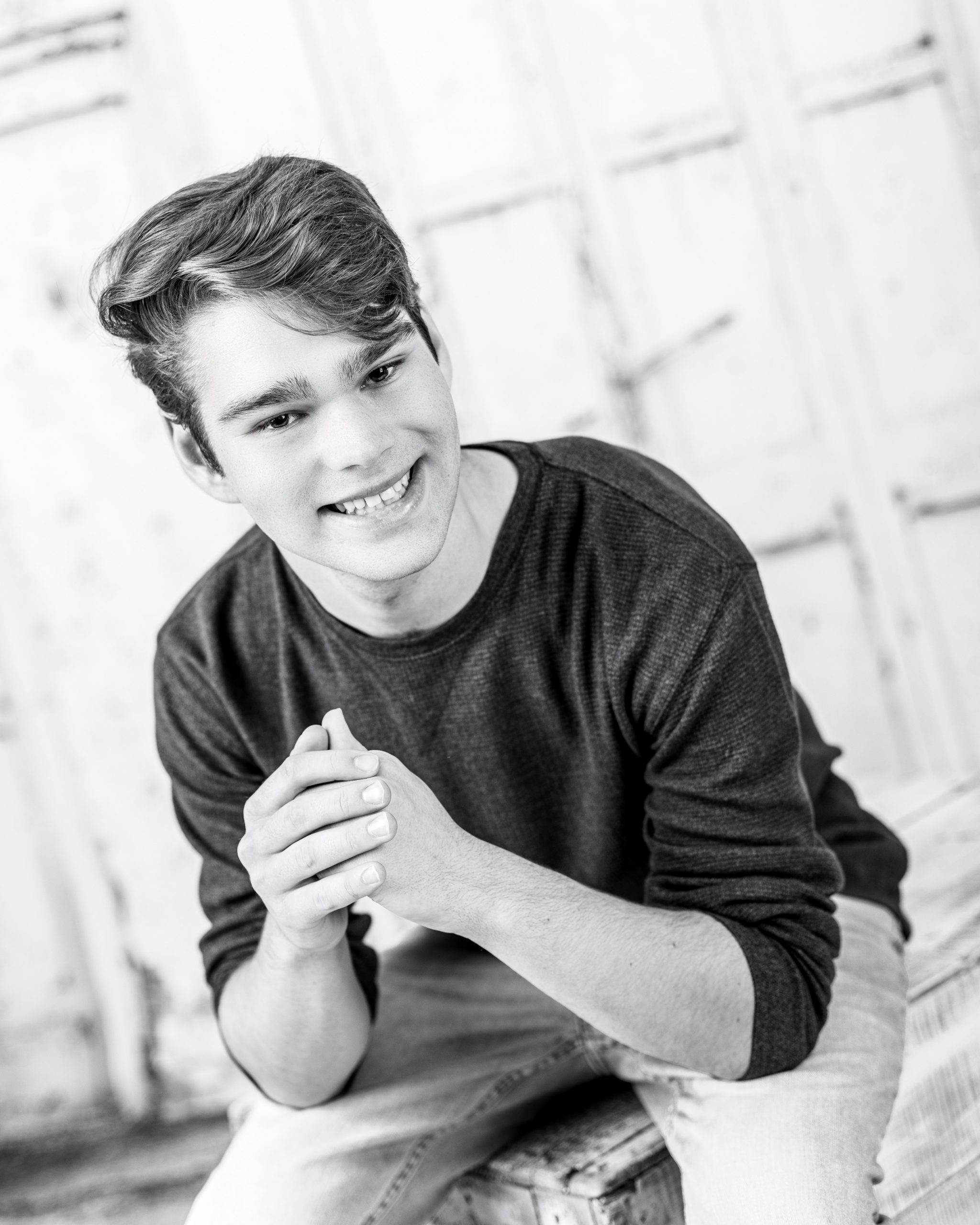 Formal senior photo of Jefferson High School student in navy suit and tie