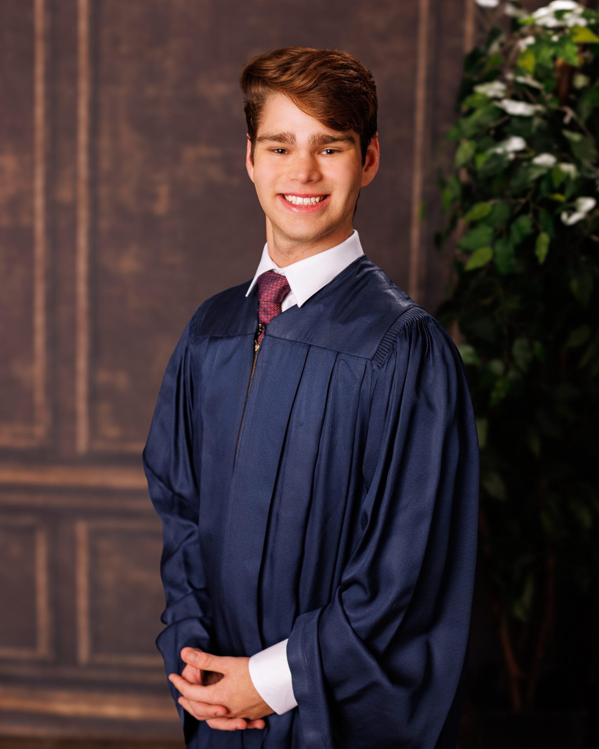 Formal senior photo of Jefferson High School student in navy suit and tie