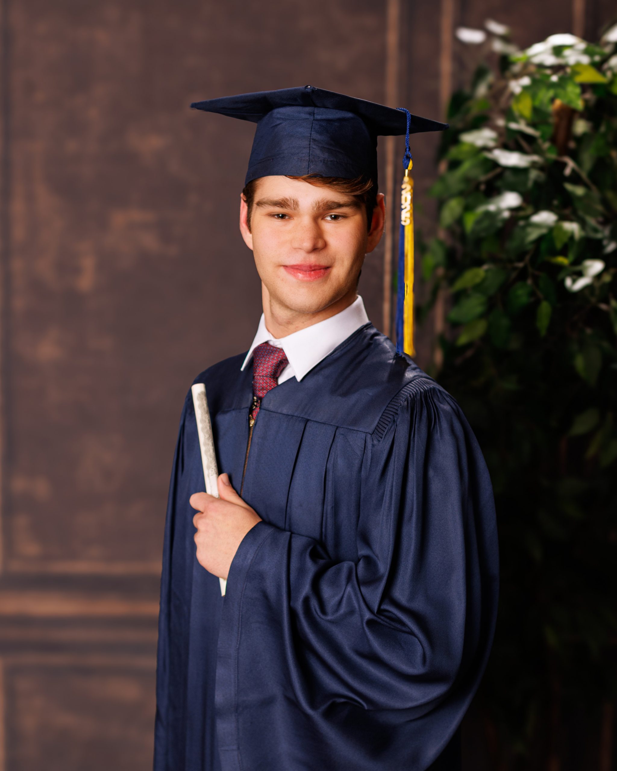 Formal senior photo of Jefferson High School student in navy suit and tie