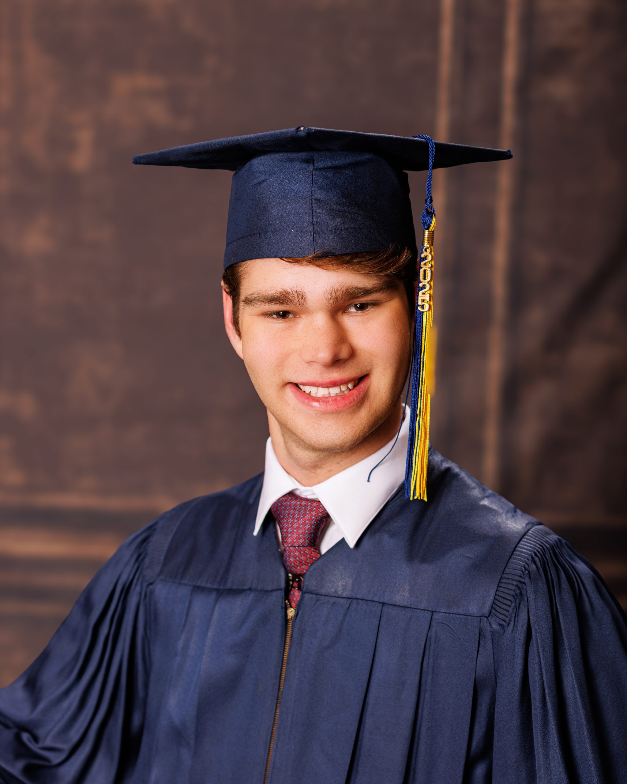 Formal senior photo of Jefferson High School student in navy suit and tie