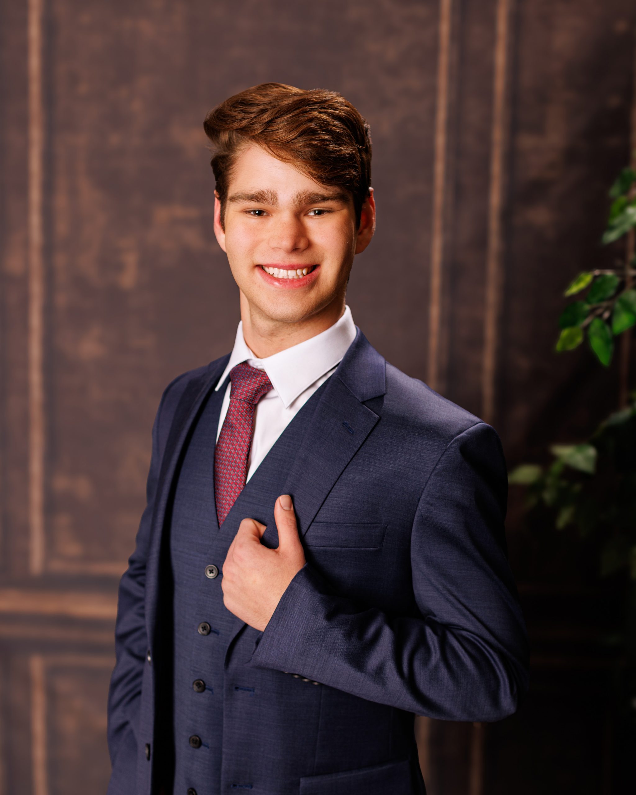 Formal senior photo of Jefferson High School student in navy suit and tie