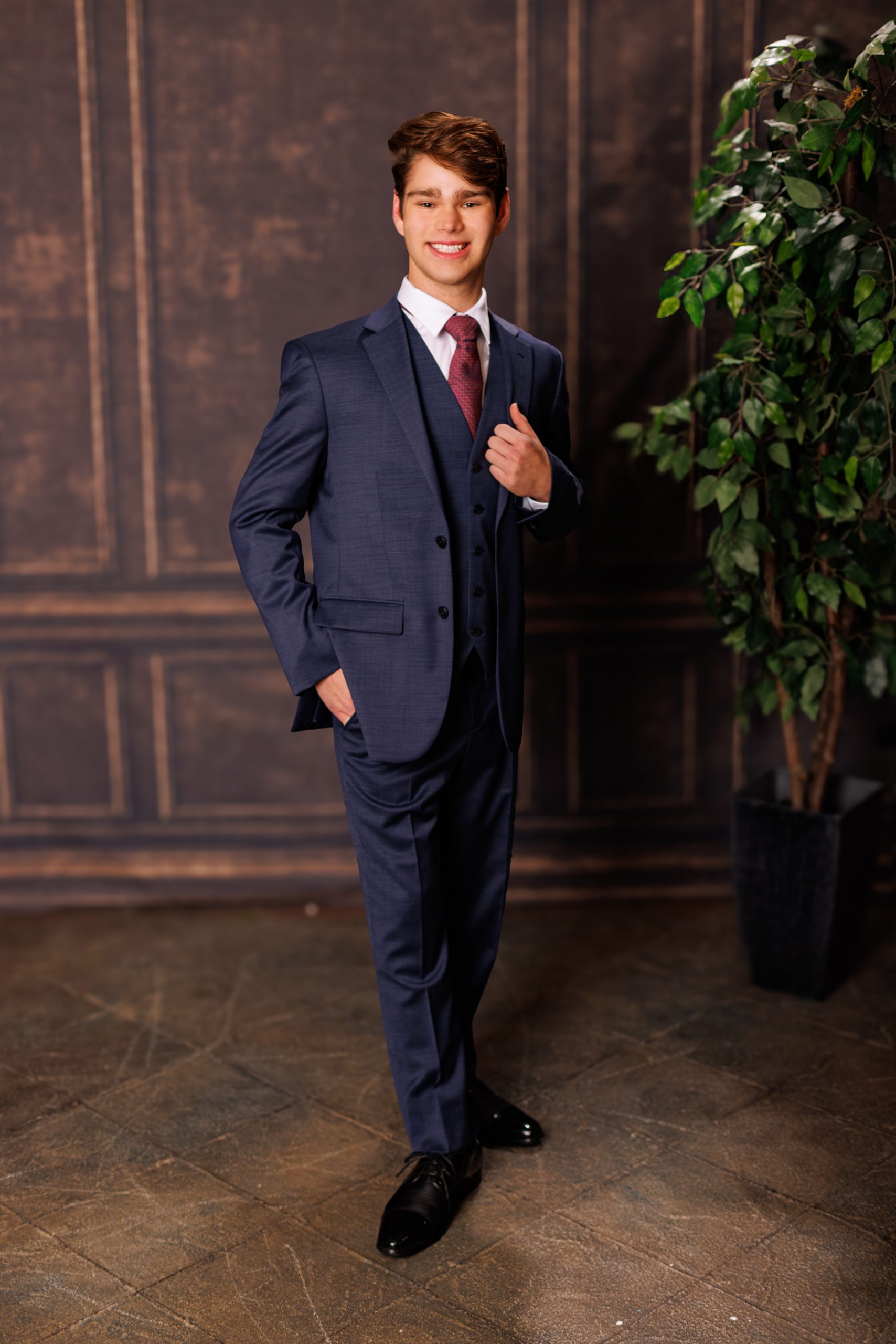Formal senior photo of Jefferson High School student in navy suit and tie