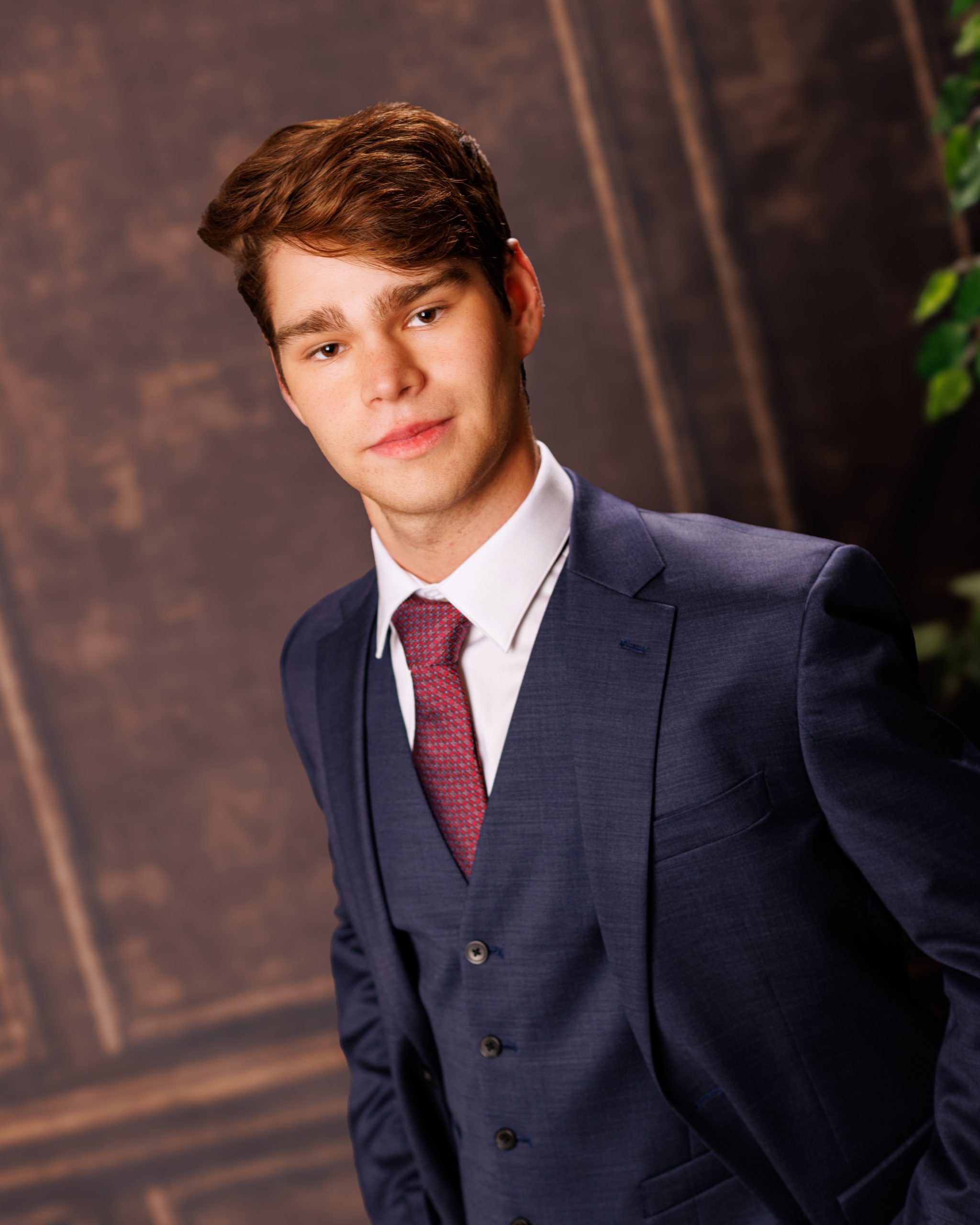 Formal senior photo of Jefferson High School student in navy suit and tie