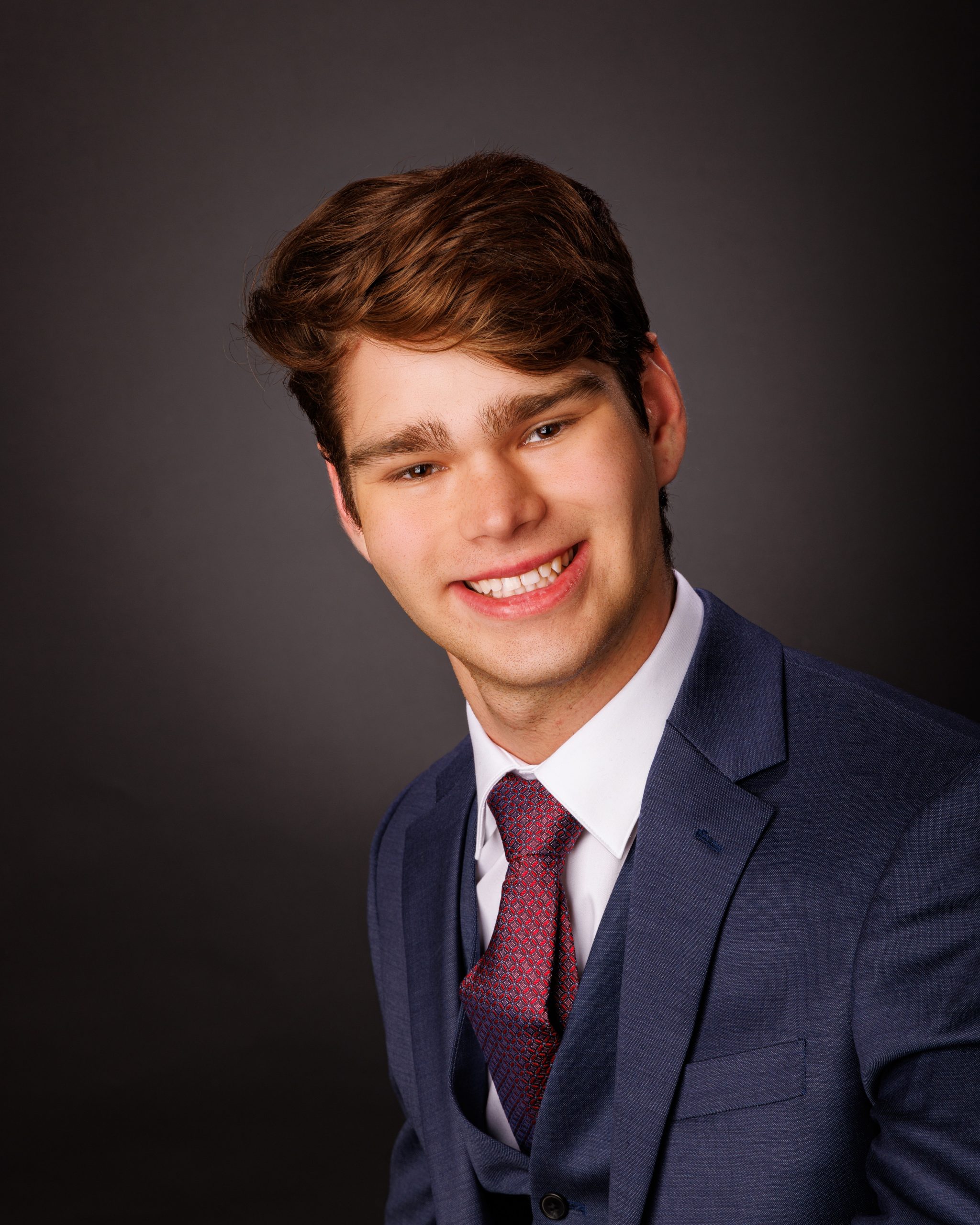 Formal senior photo of Jefferson High School student in navy suit and tie