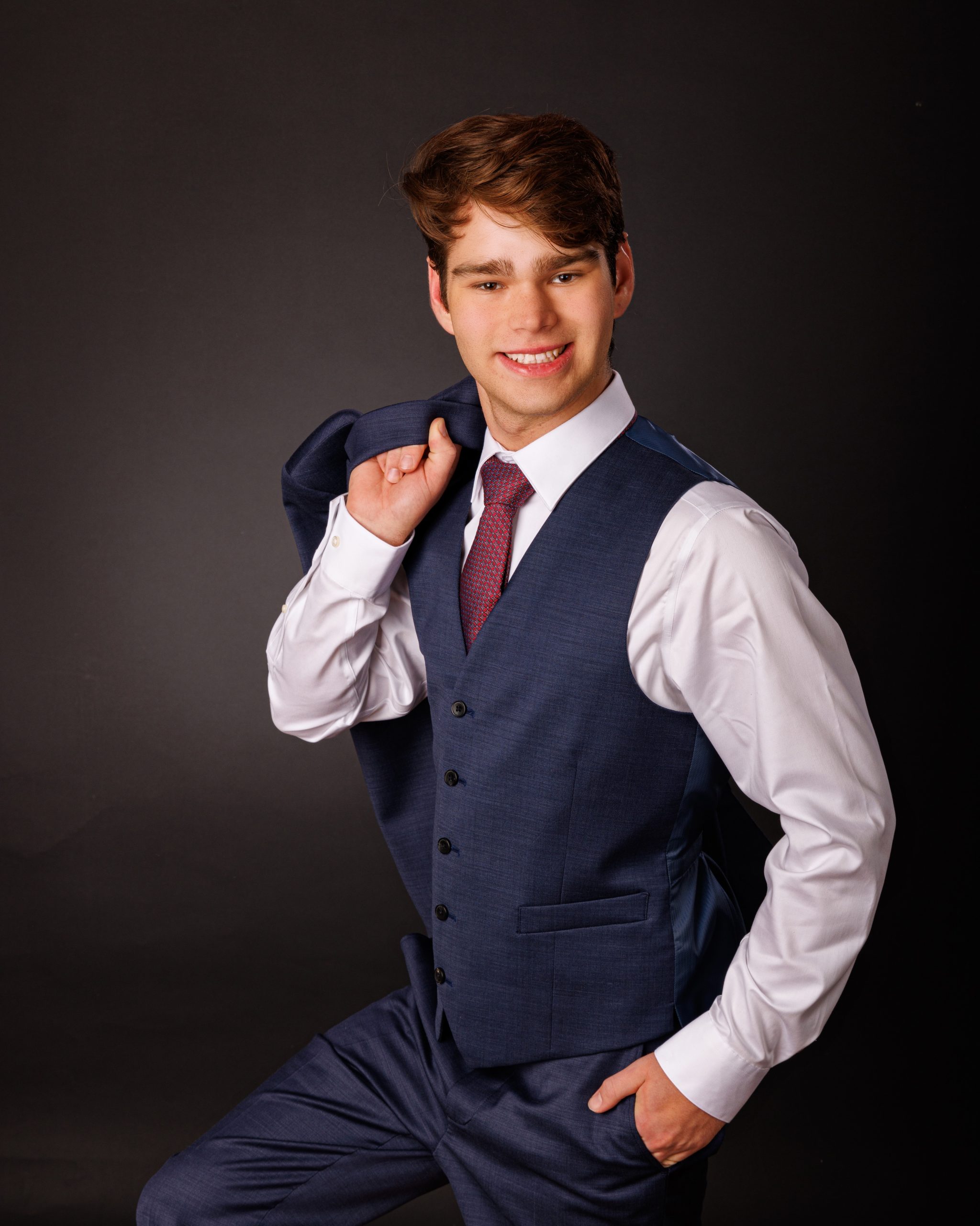 Formal senior photo of Jefferson High School student in navy suit and tie