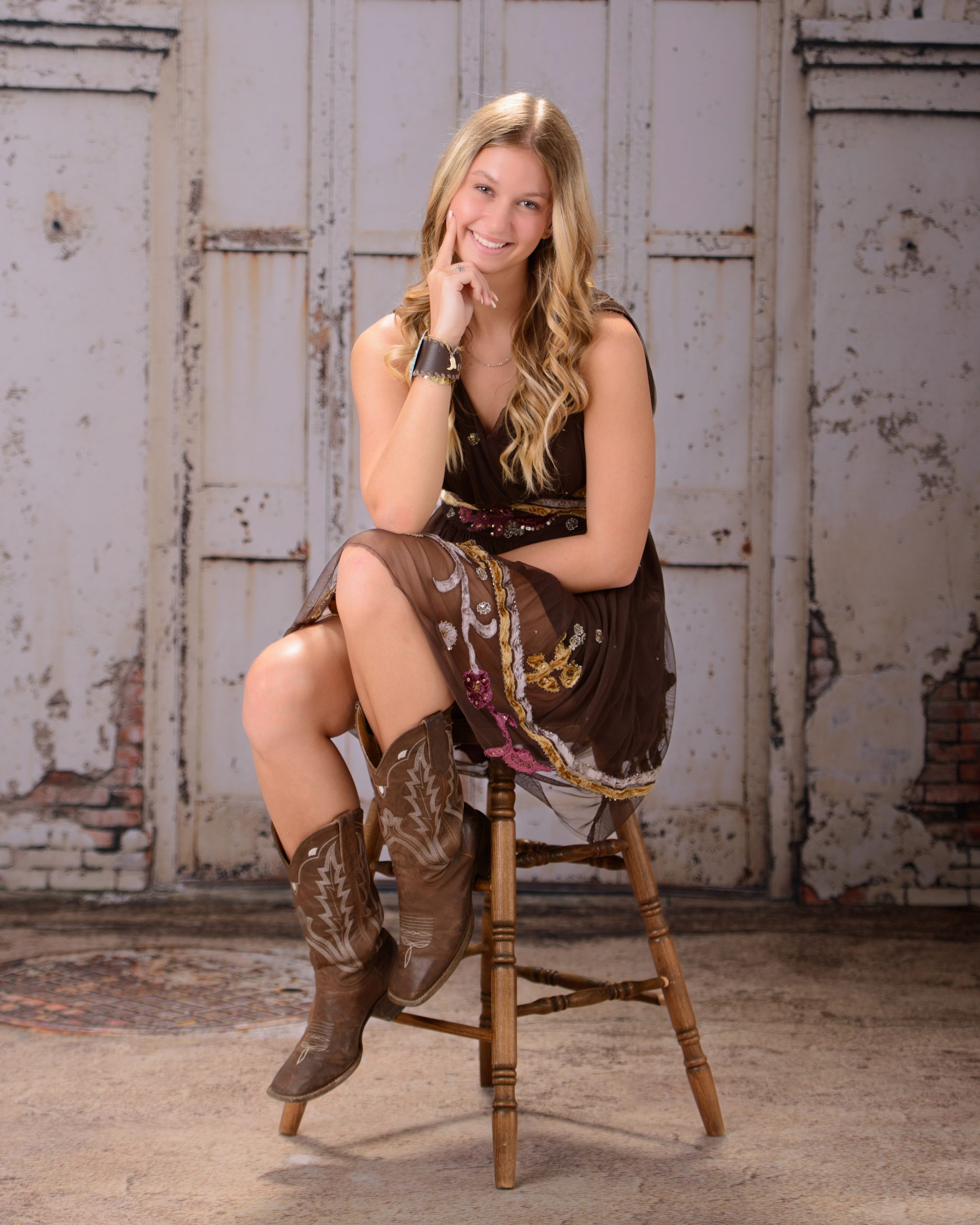 Kacey Allen Park senior portrait seated on wooden stool with confident smile