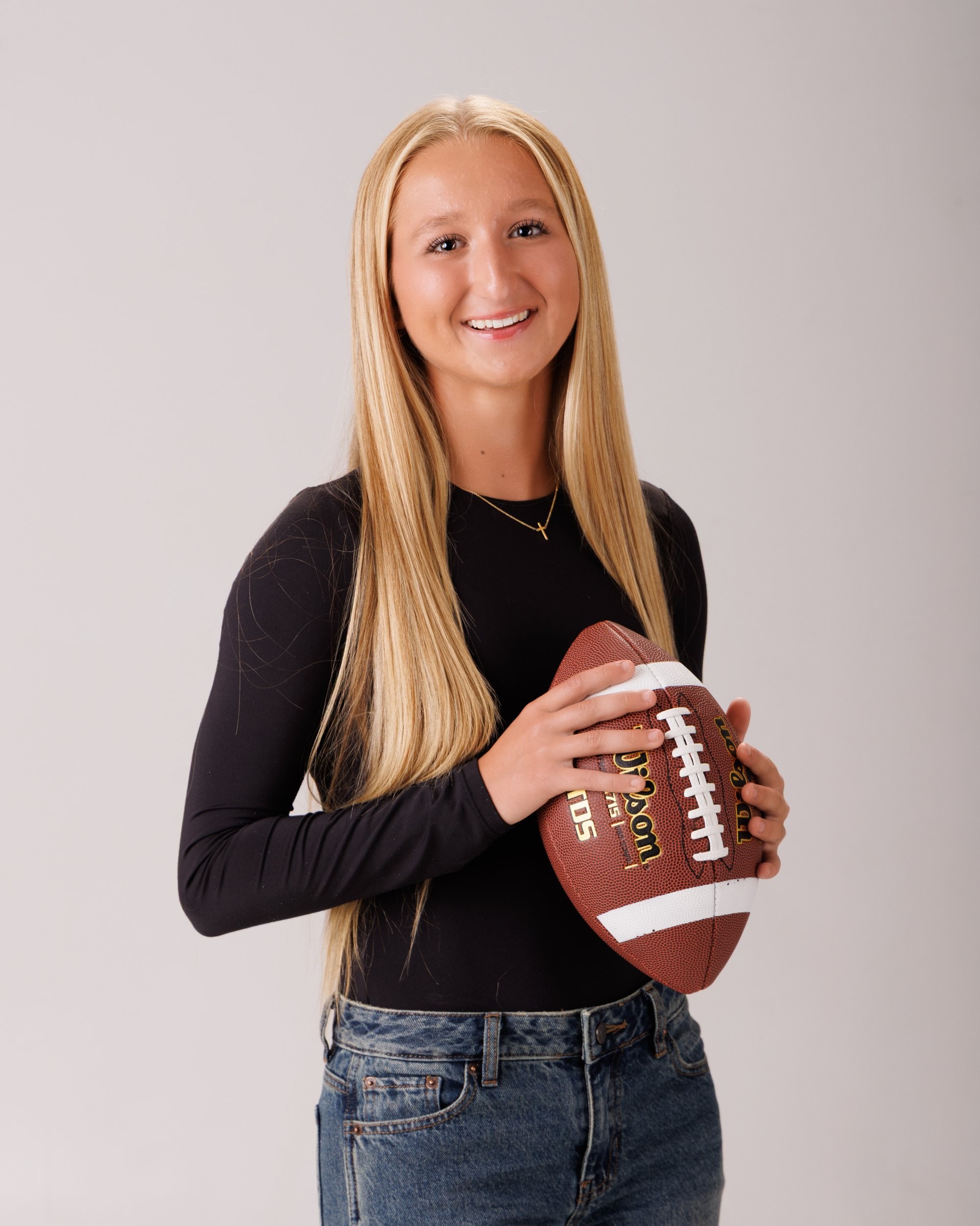 Madison holding soccer ball in senior portraits