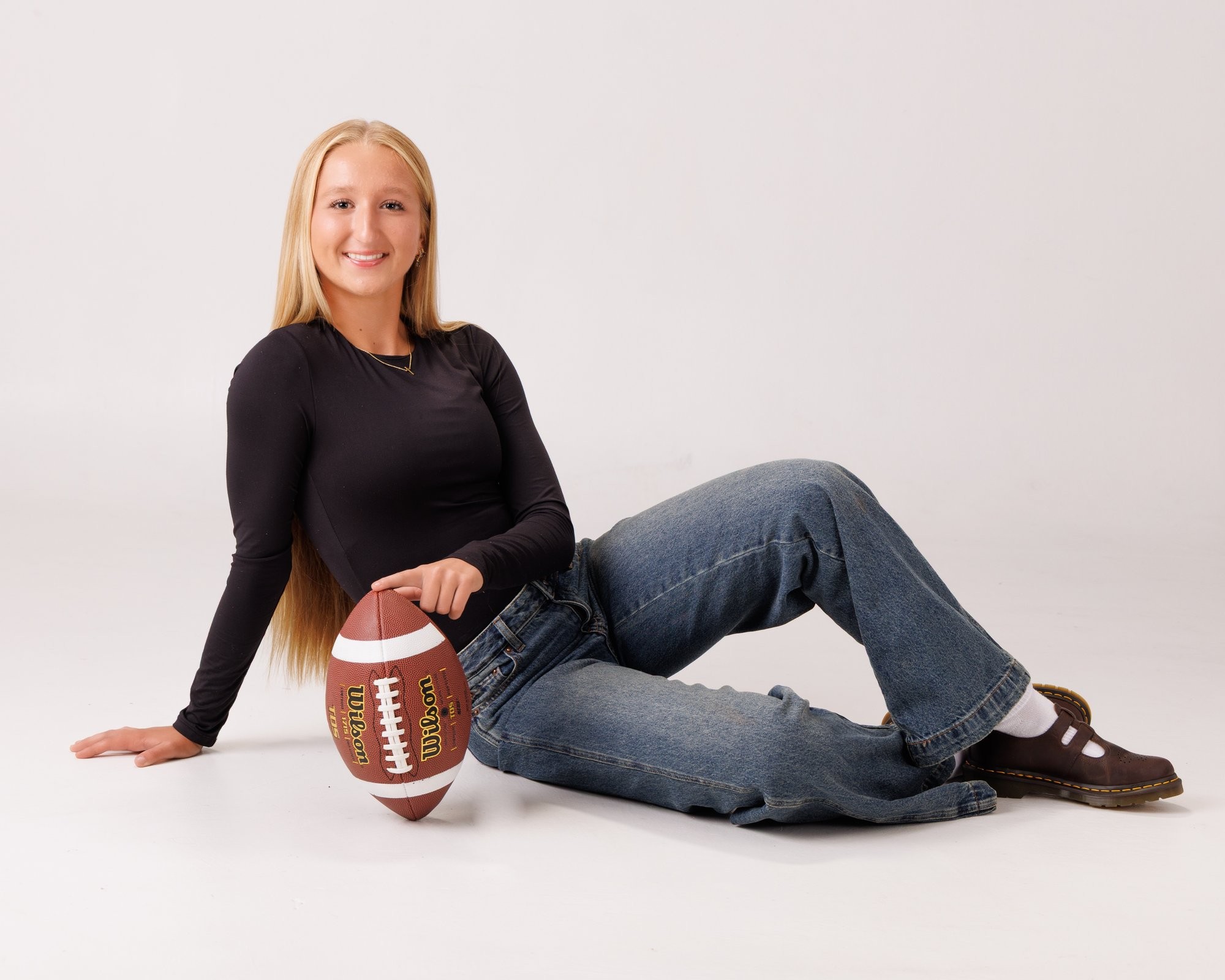 Madison holding soccer ball in senior portraits