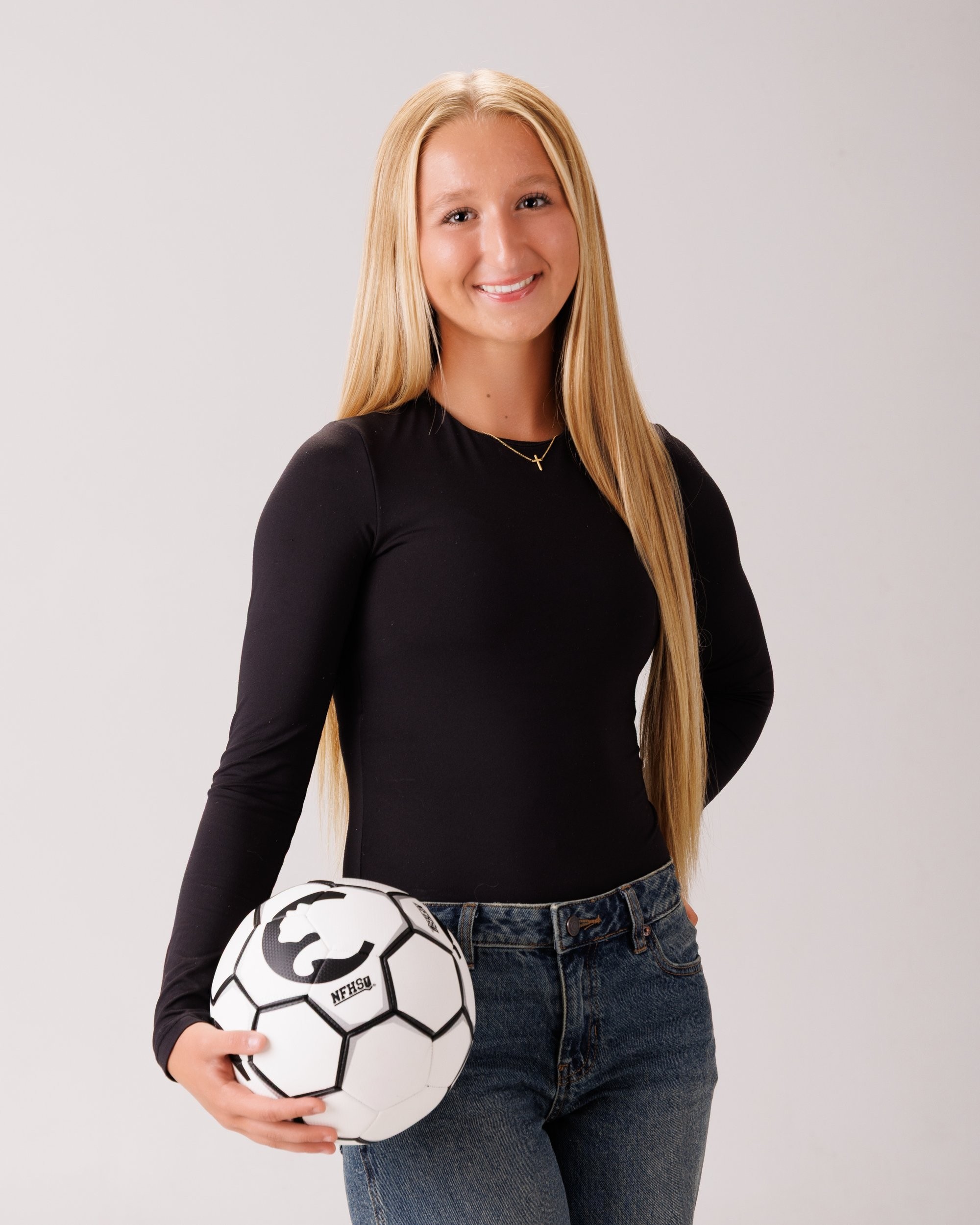 Madison holding soccer ball in senior portraits