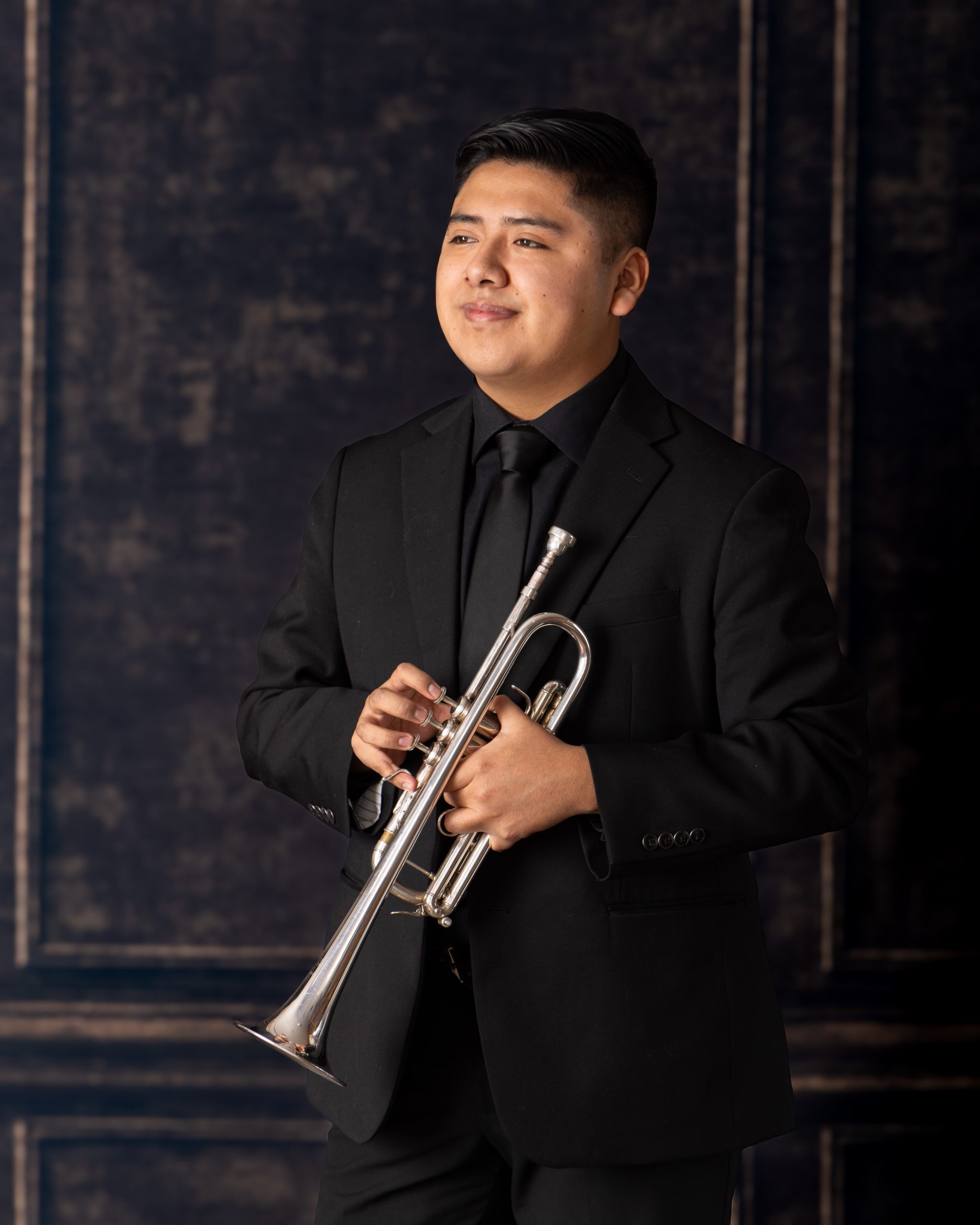 Senior musician performing on trumpet with focused expression