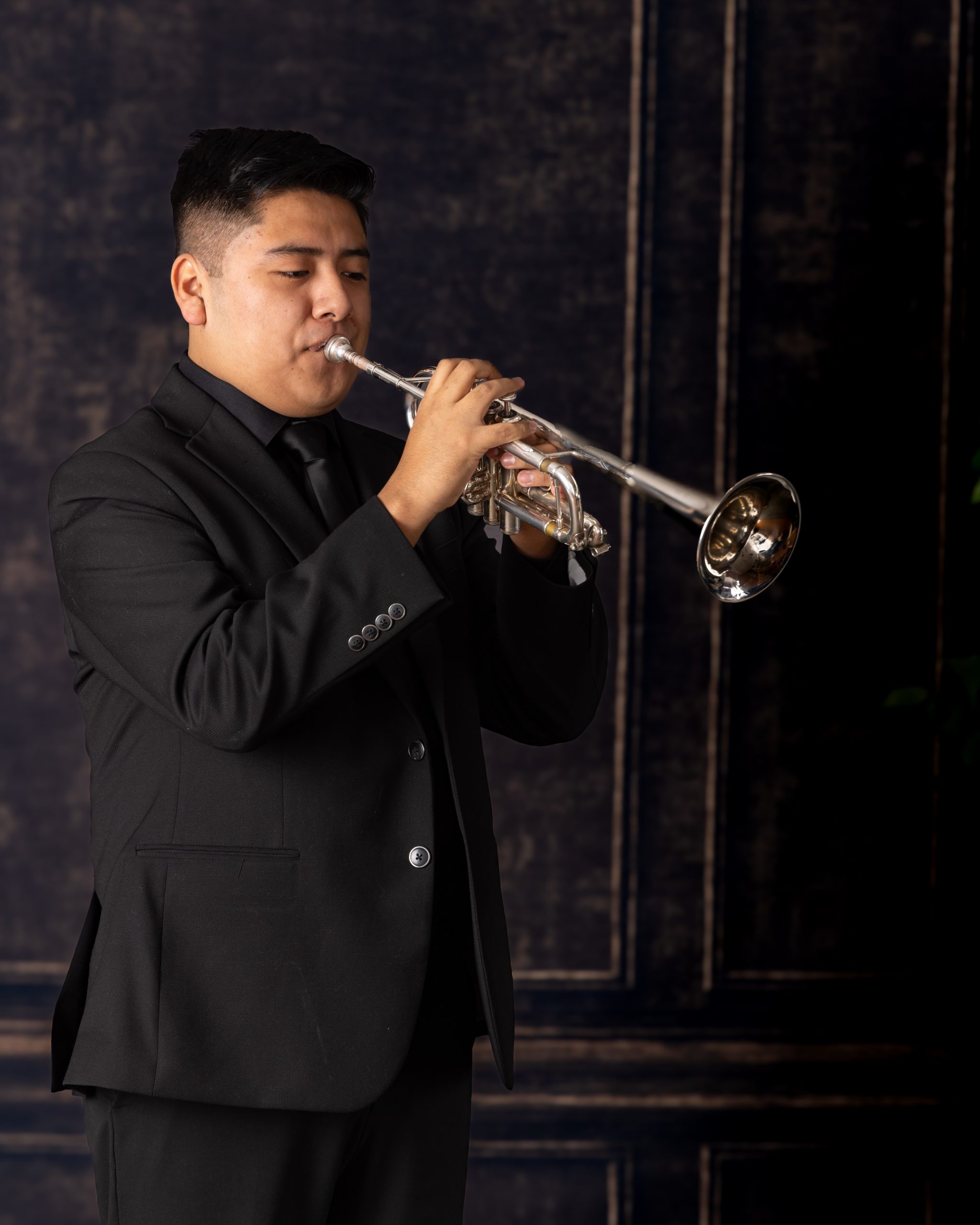 Senior musician performing on trumpet with focused expression