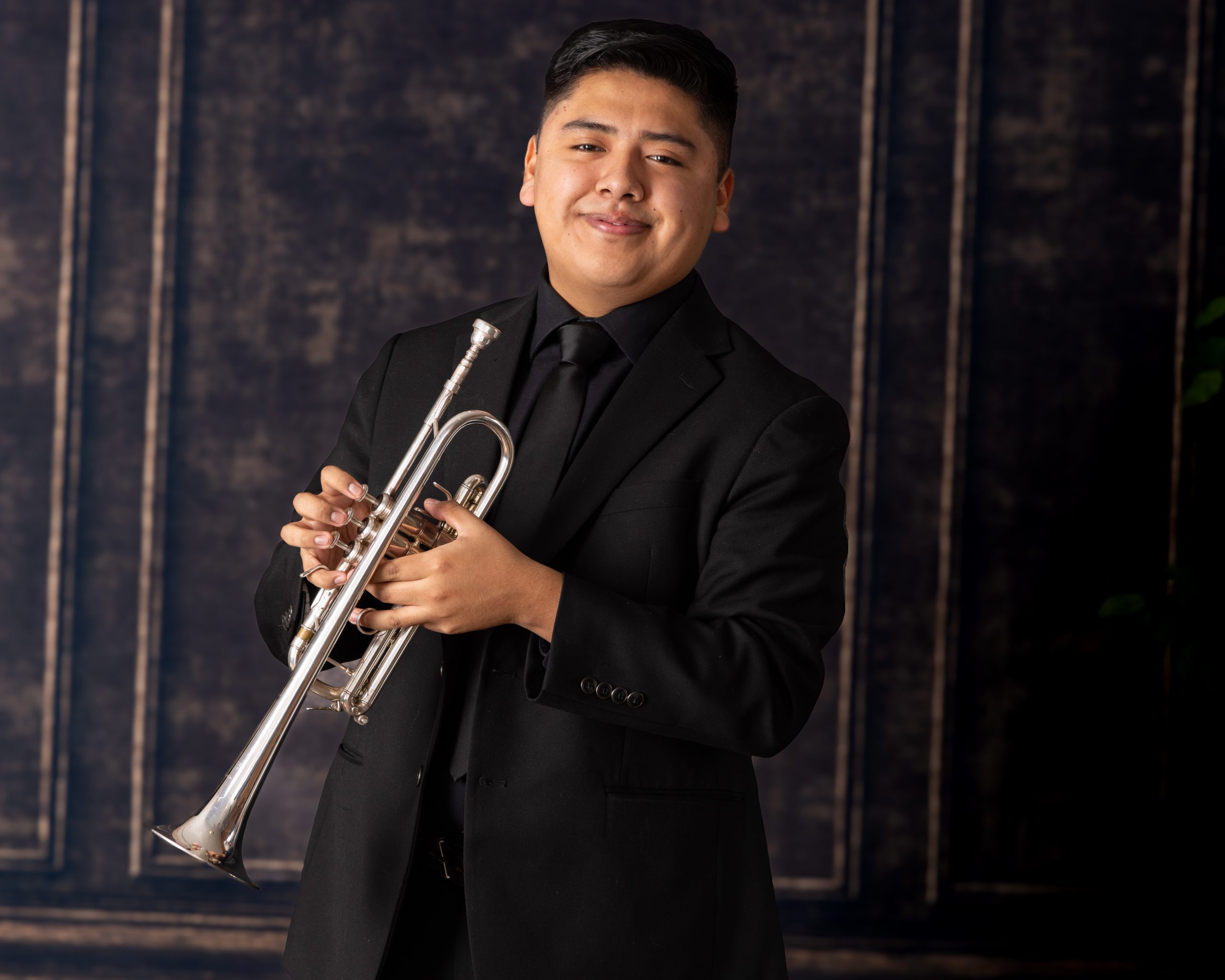 Senior musician performing on trumpet with focused expression