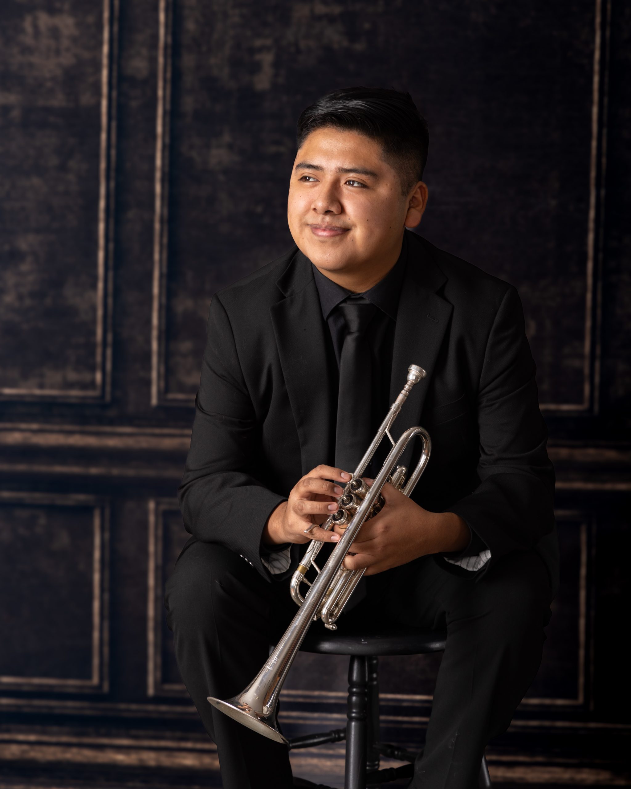Senior musician performing on trumpet with focused expression