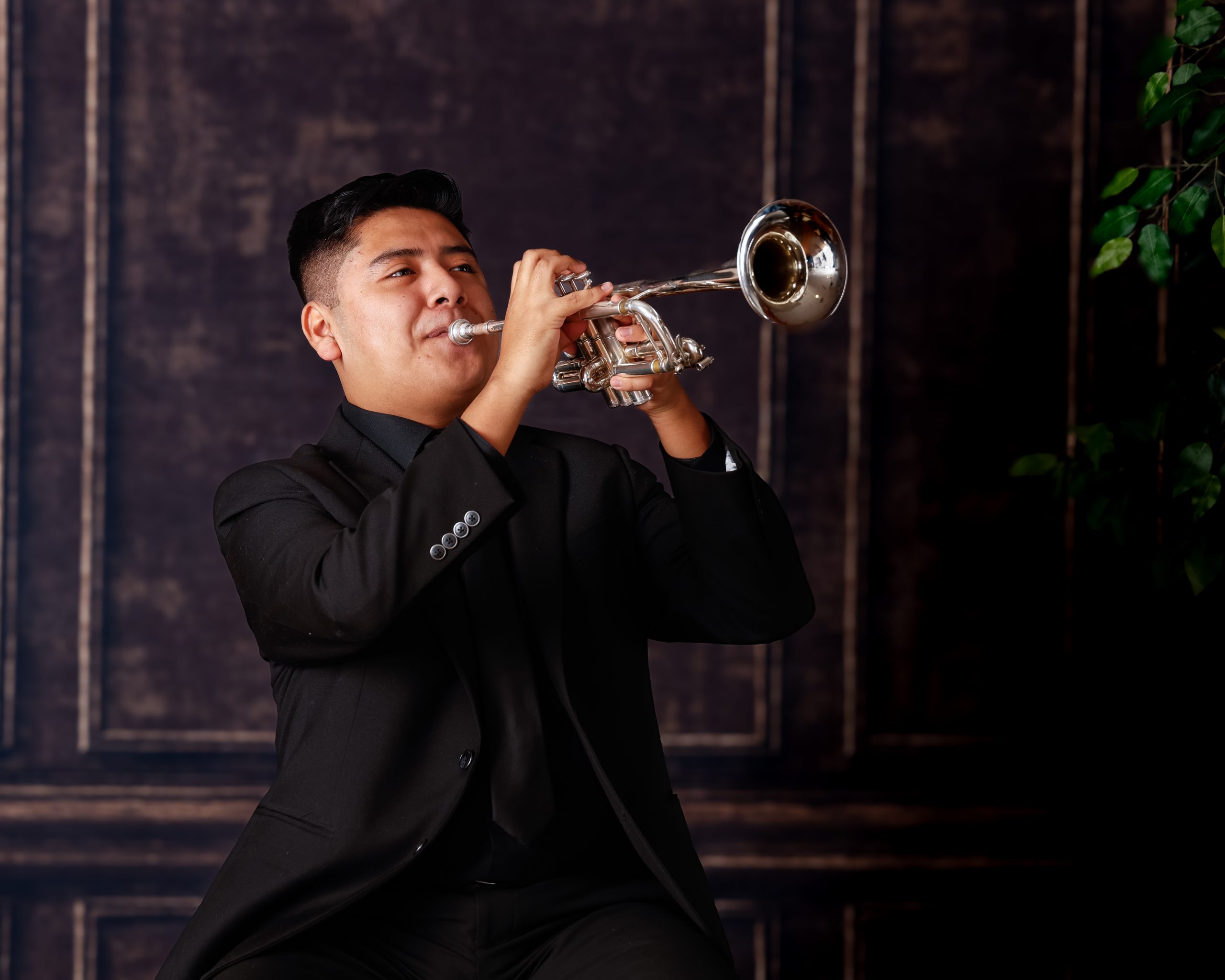Senior musician performing on trumpet with focused expression