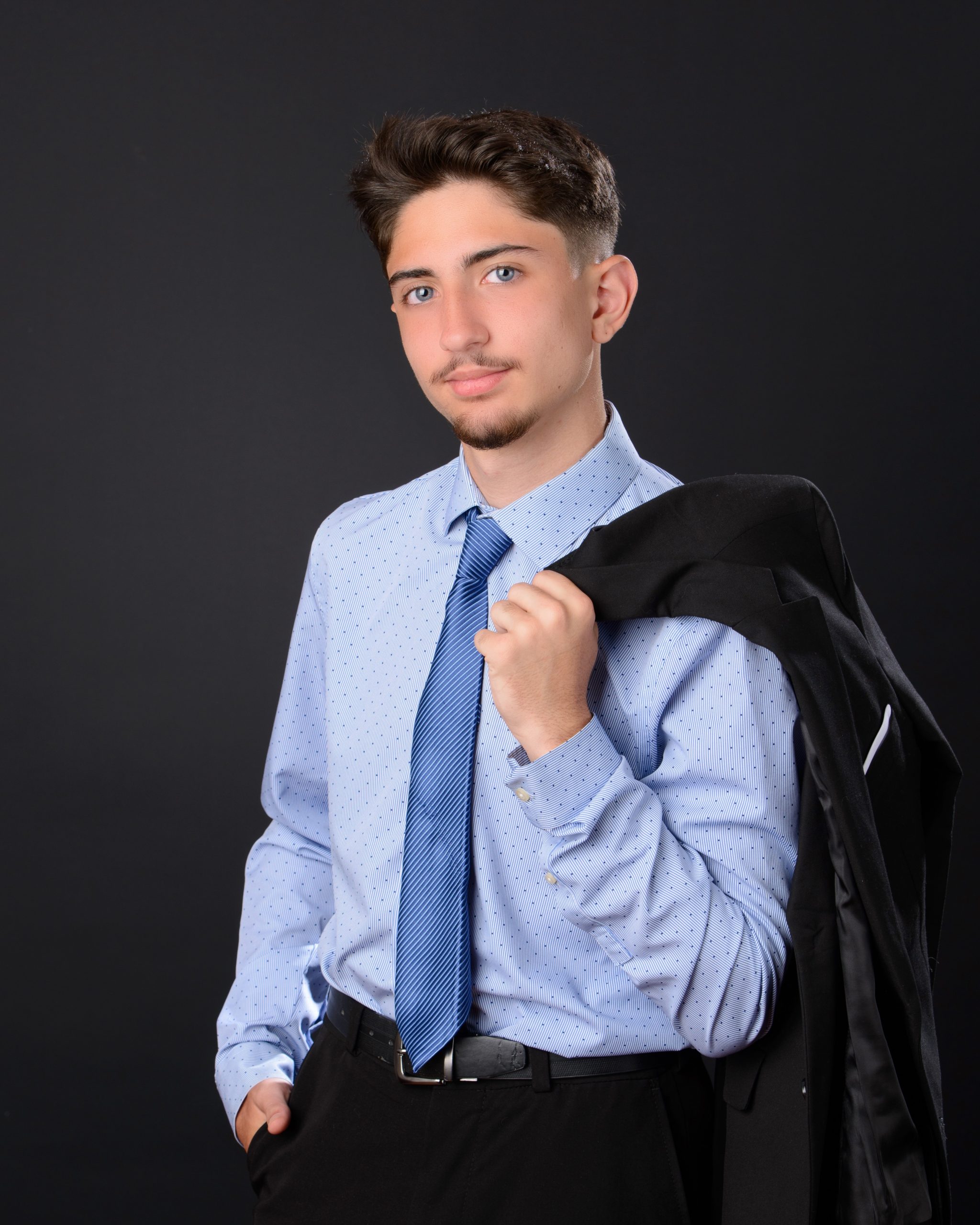 formal business portrait of Sean in black suit and blue tie