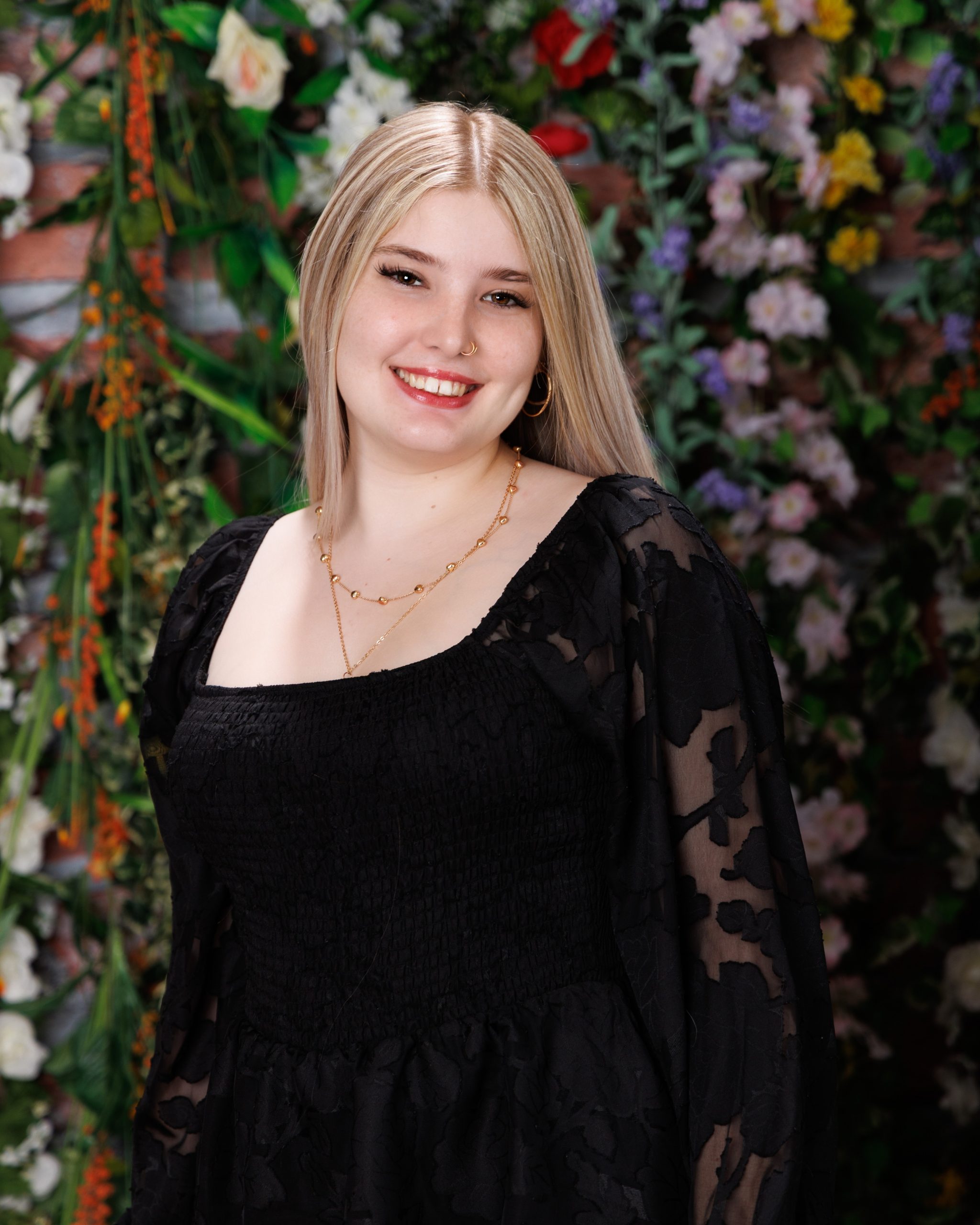 Alysha holding blue graduation cap and gown during senior photography session