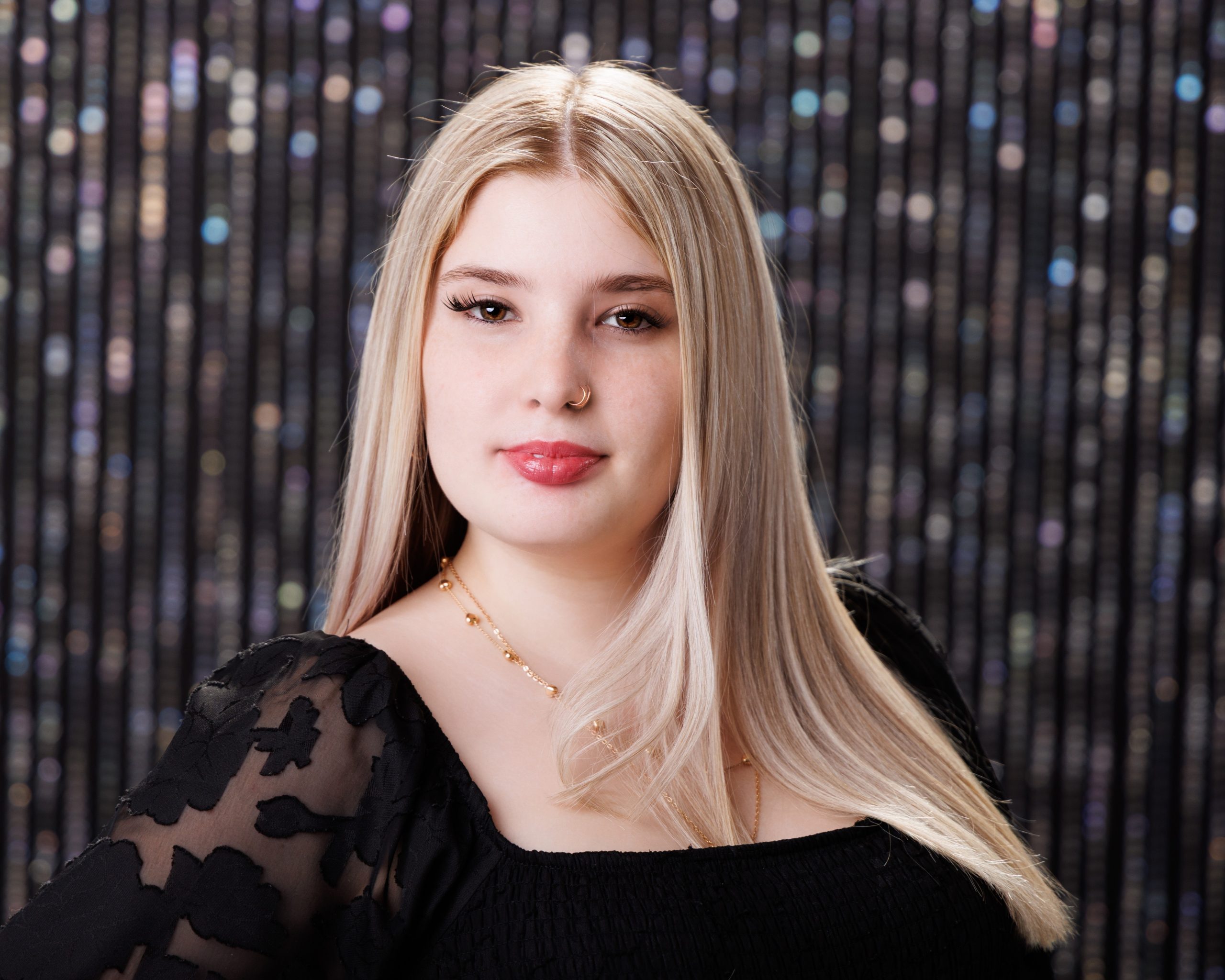Alysha holding blue graduation cap and gown during senior photography session