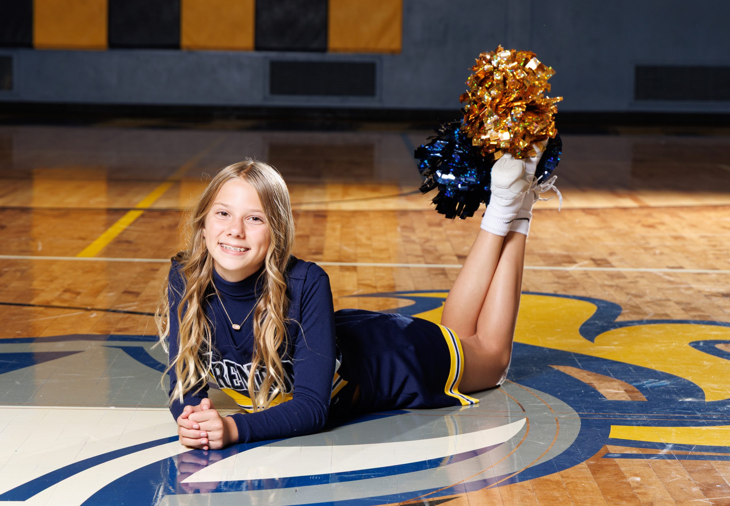 Trenton cheerleader lying on court with raised legs