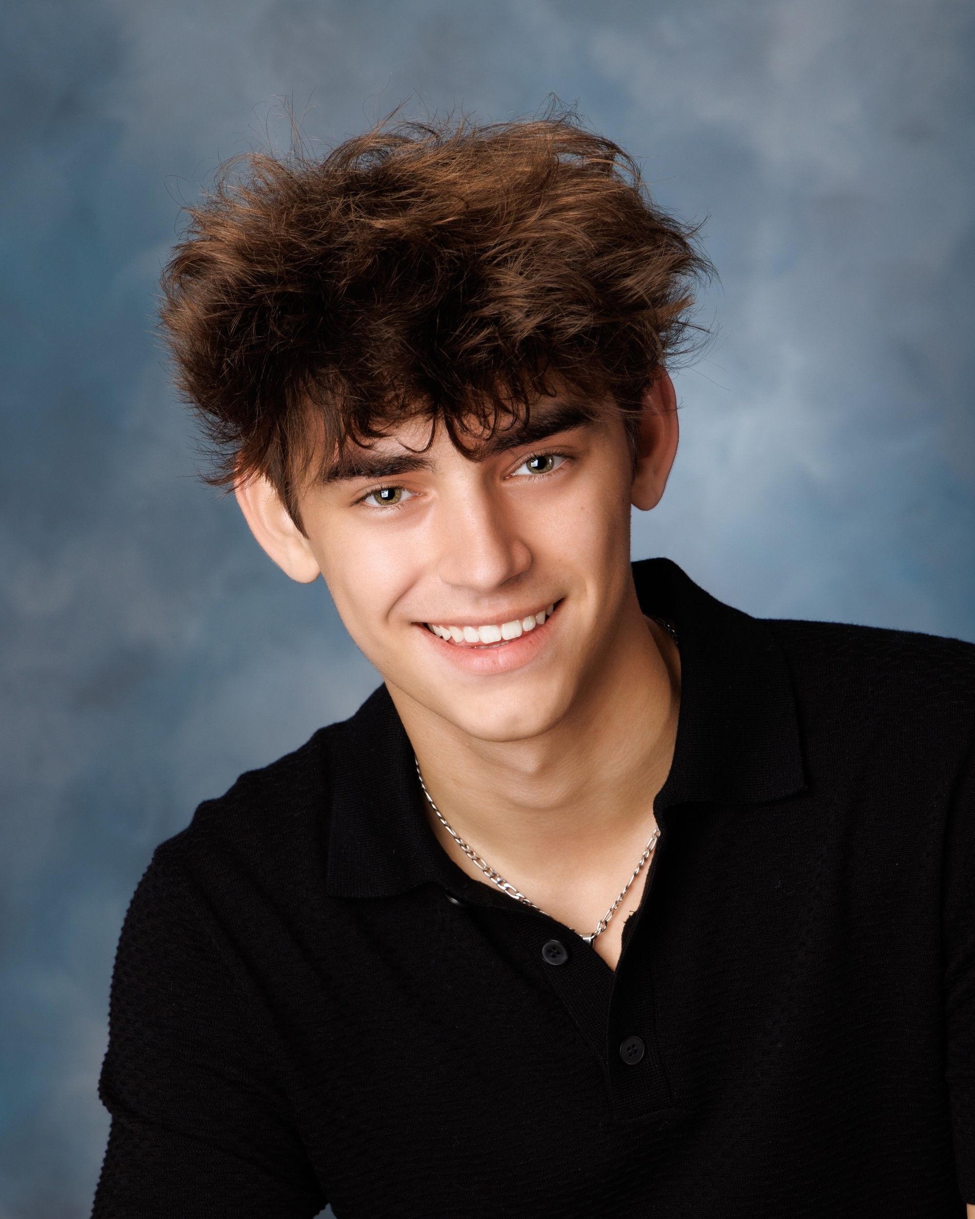 Trenton senior yearbook photo of boy with curly hair and black polo shirt