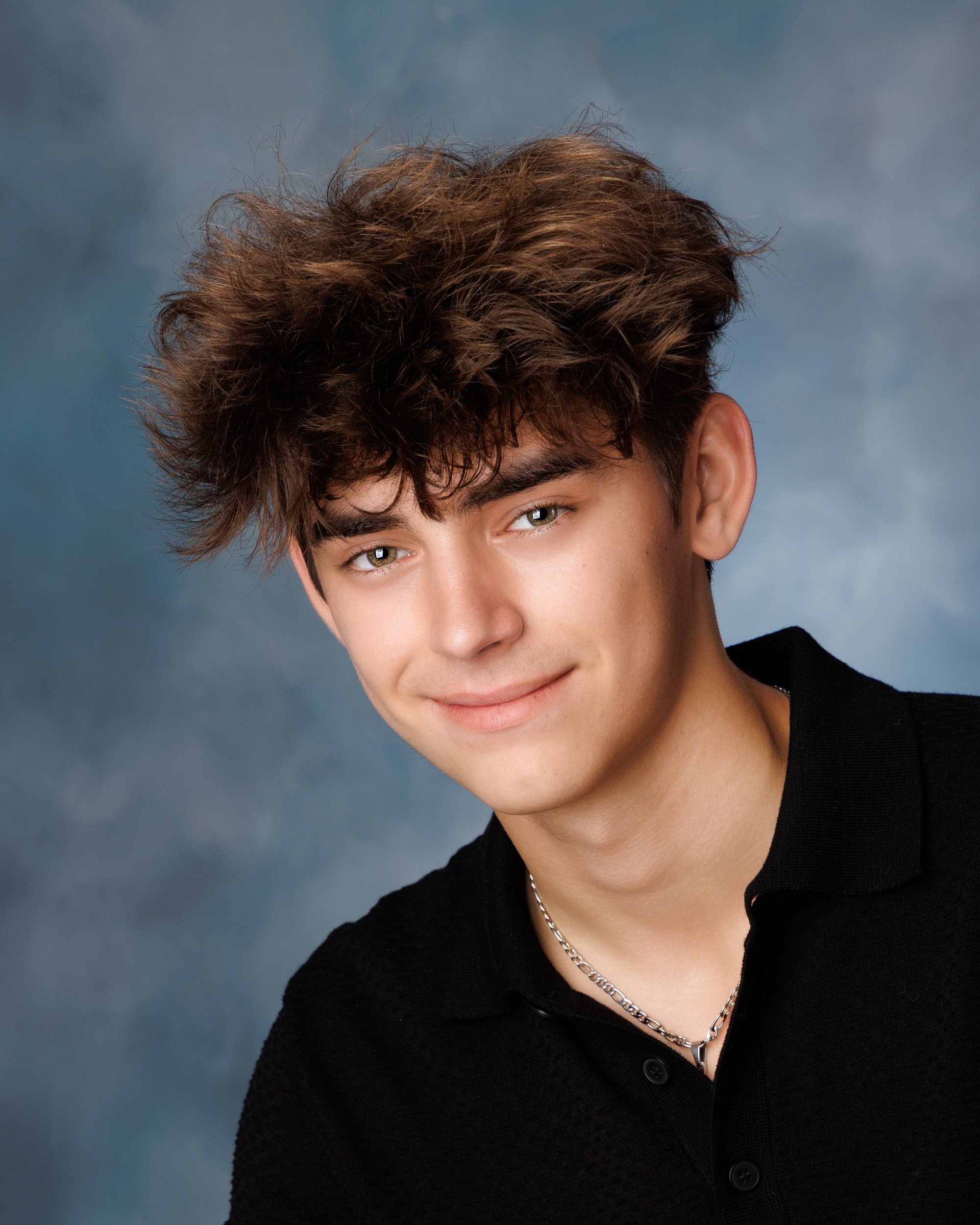 Trenton senior yearbook photo of boy wearing silver chain and black polo