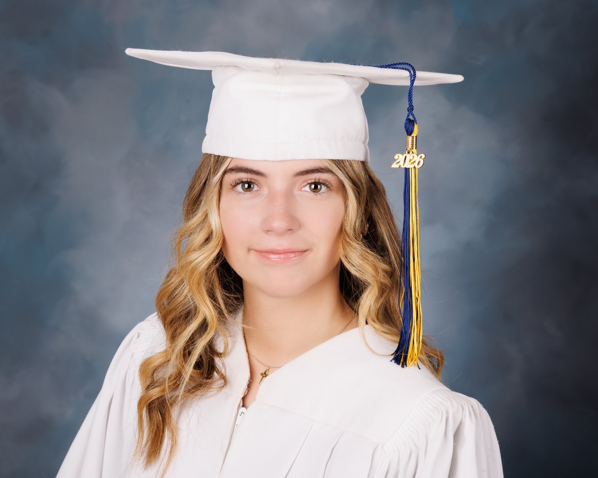 Senior graduation photo featuring a student in white gown and 2026 cap tassel, Downriver photography studio
