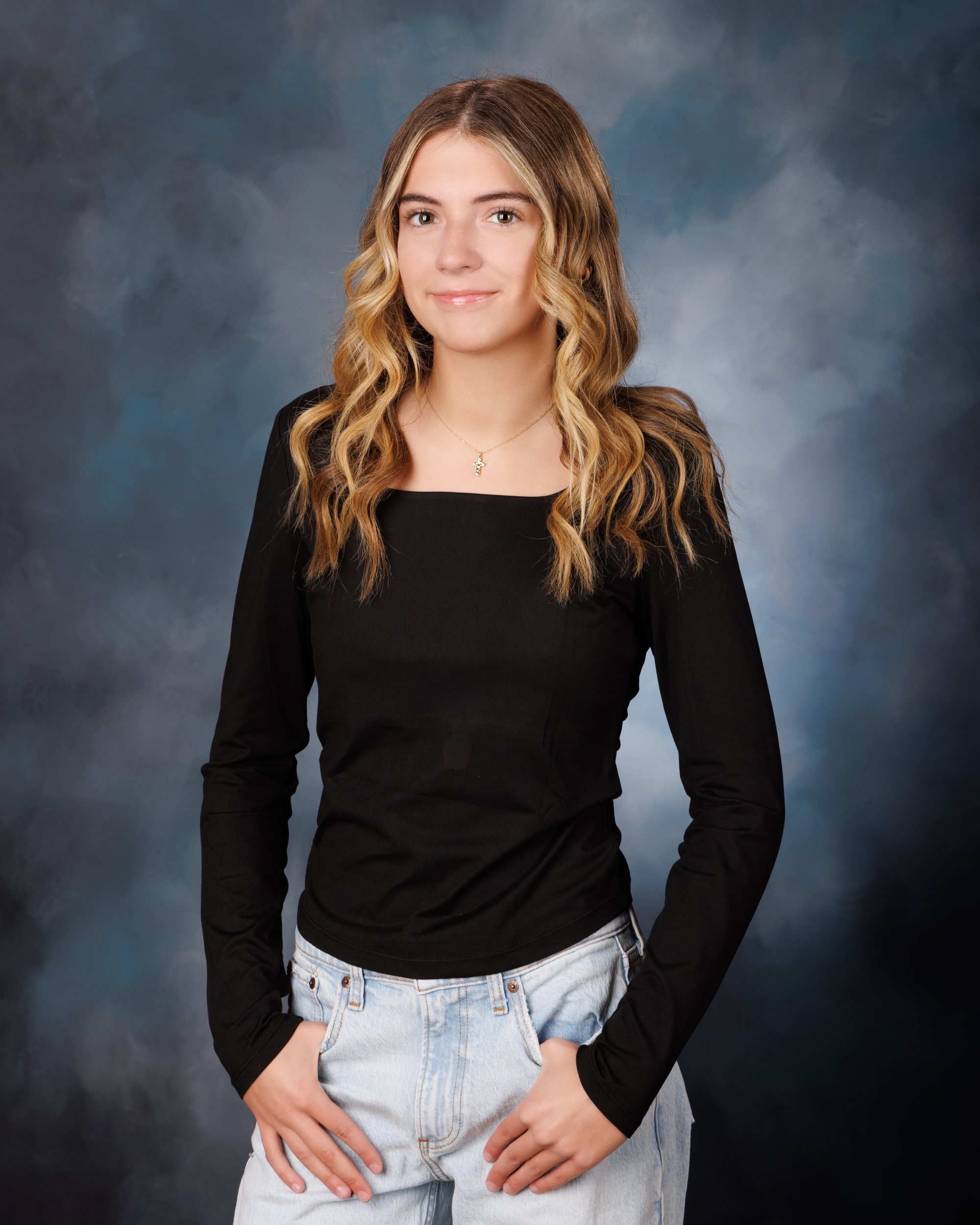 Trenton senior portraits session showing student in casual attire with graduation cap backdrop