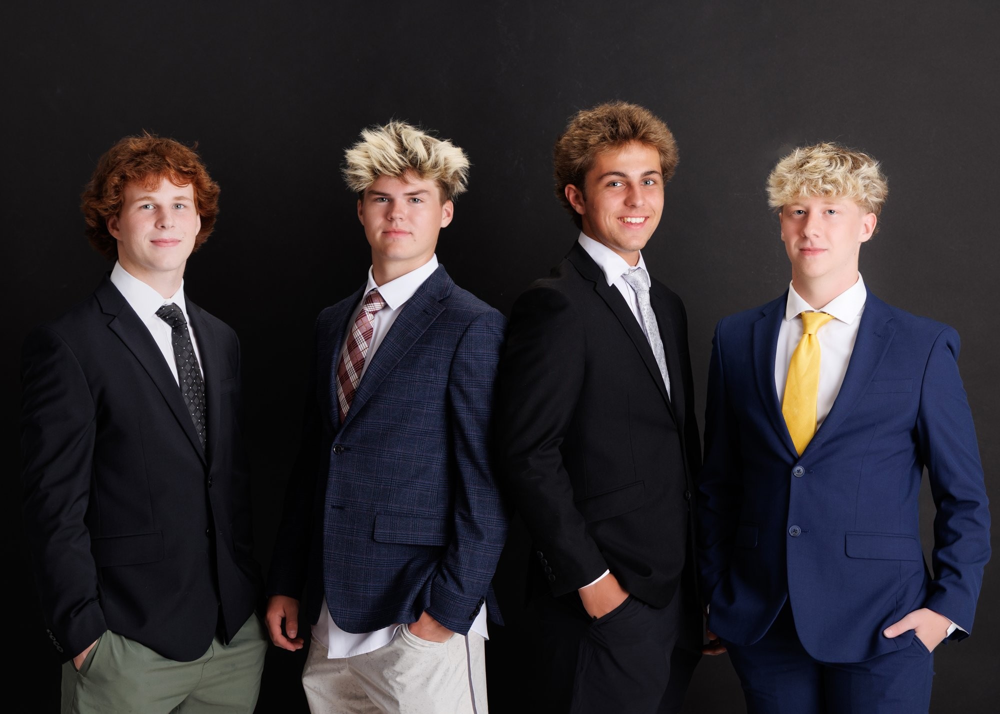 Four Trenton senior students standing together in formal attire for Downriver photo studio portraits
