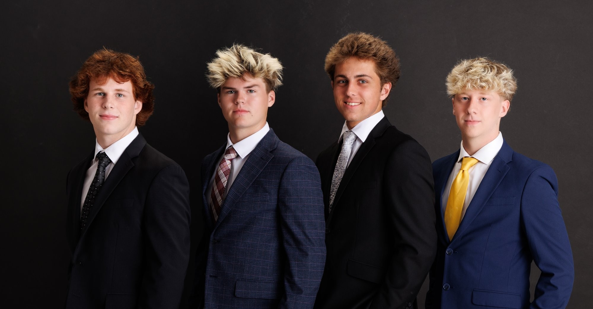 Four Trenton senior students standing together in formal attire for Downriver photo studio portraits