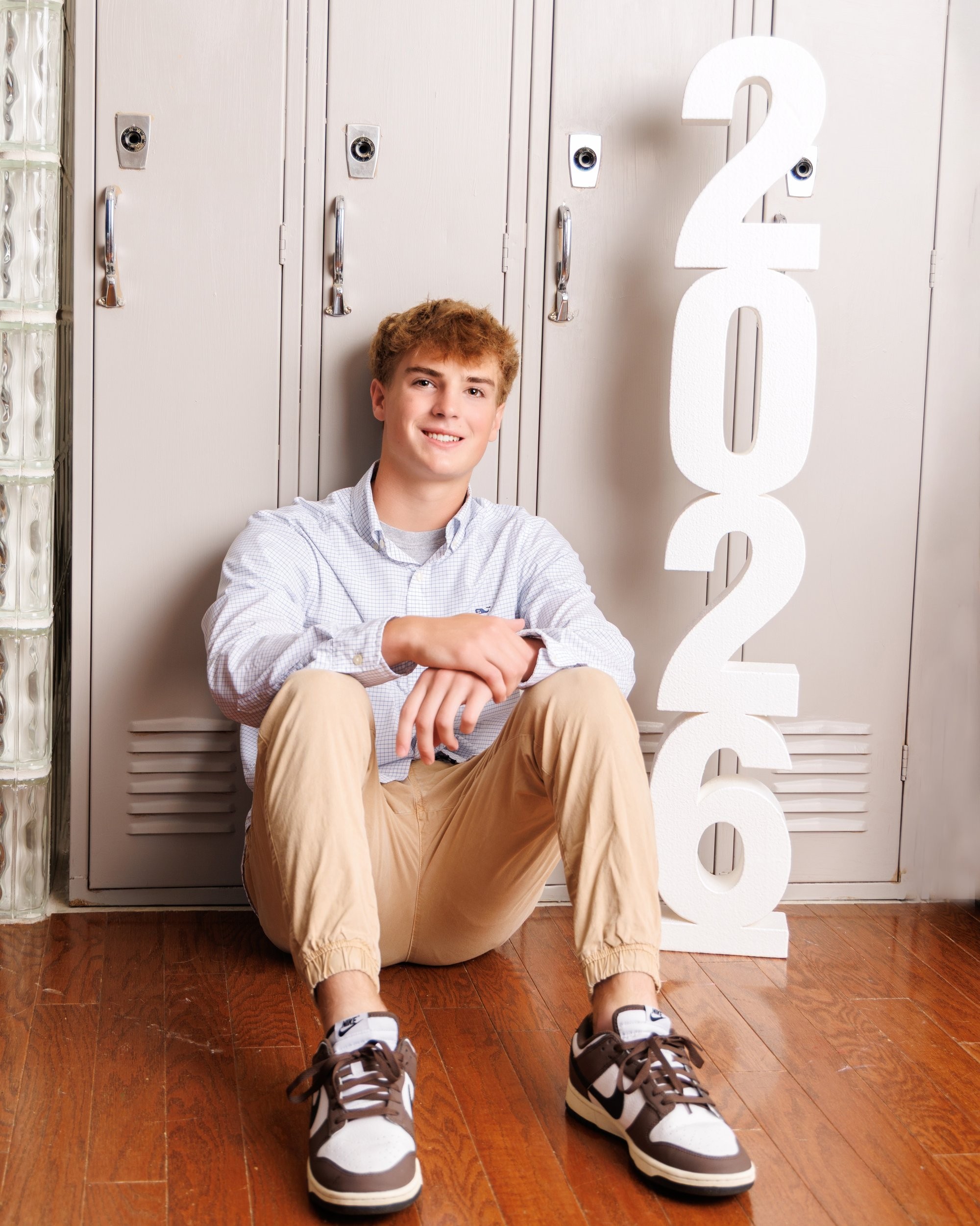 Jaxon juggling a tennis ball in a light blue checkered shirt, Trenton senior portraits