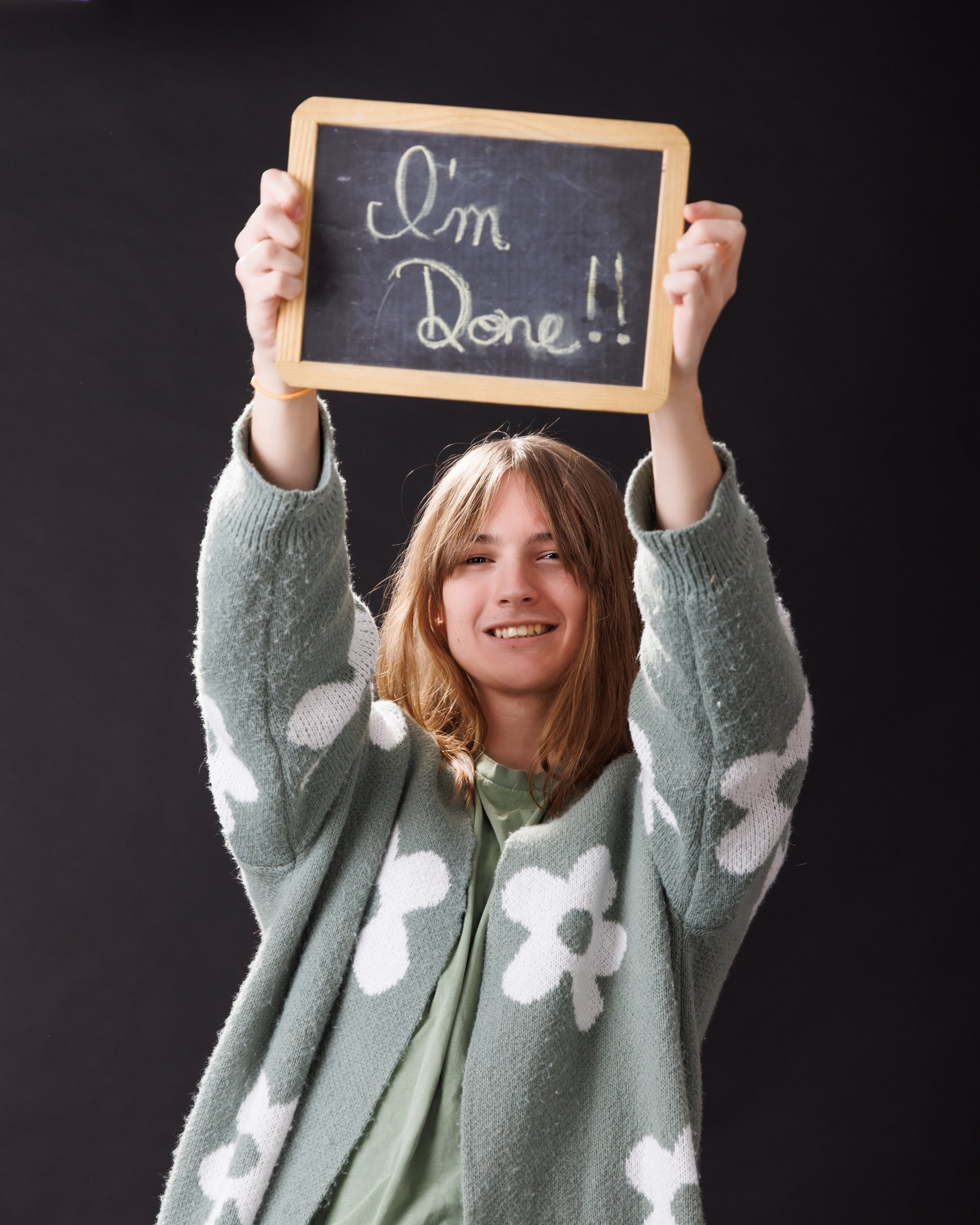 Patrick celebrates his senior year with a 'I'm Done!!' sign during a Trenton photography session